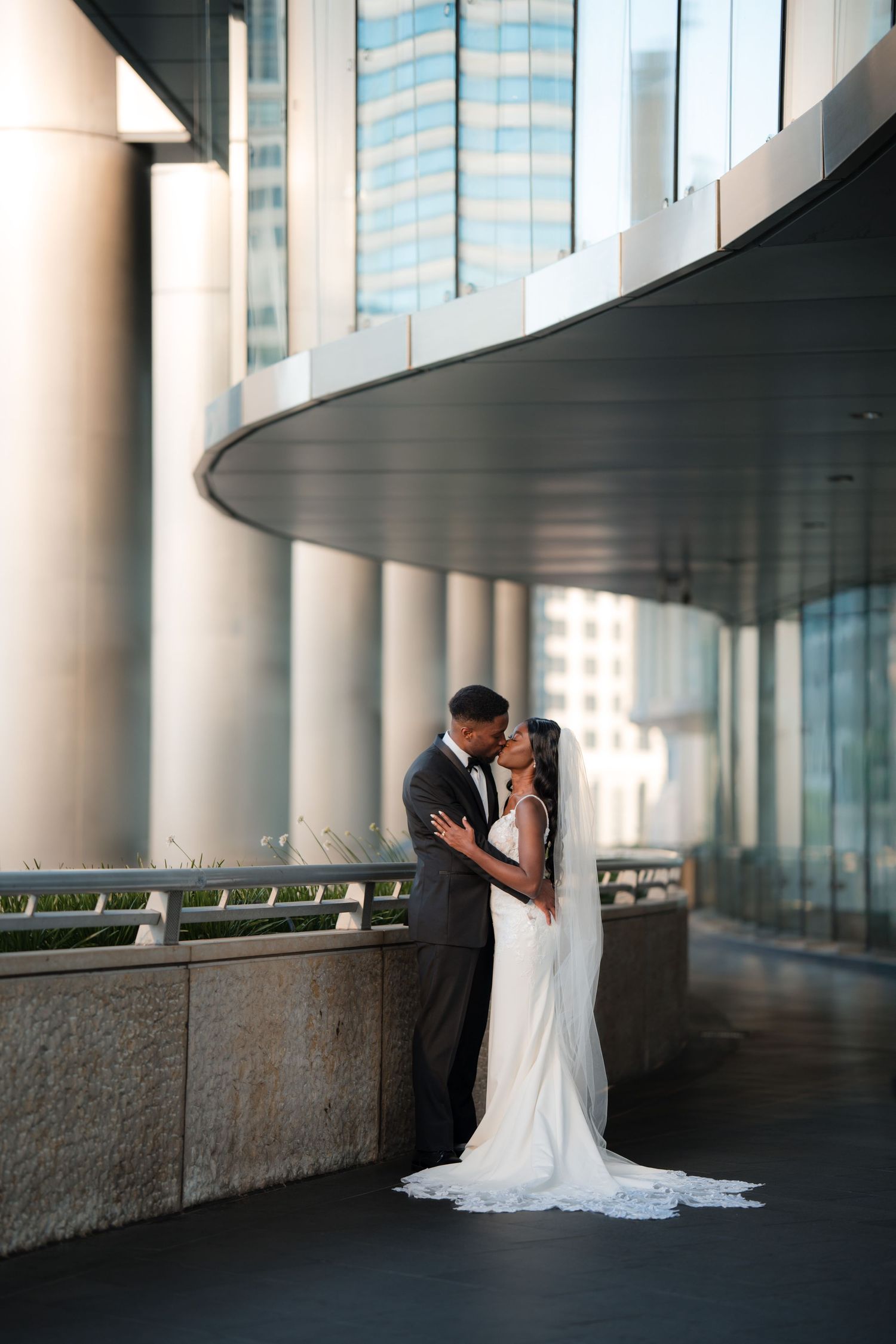 Modern architectural wedding photos with dramatic lighting and columns in background.