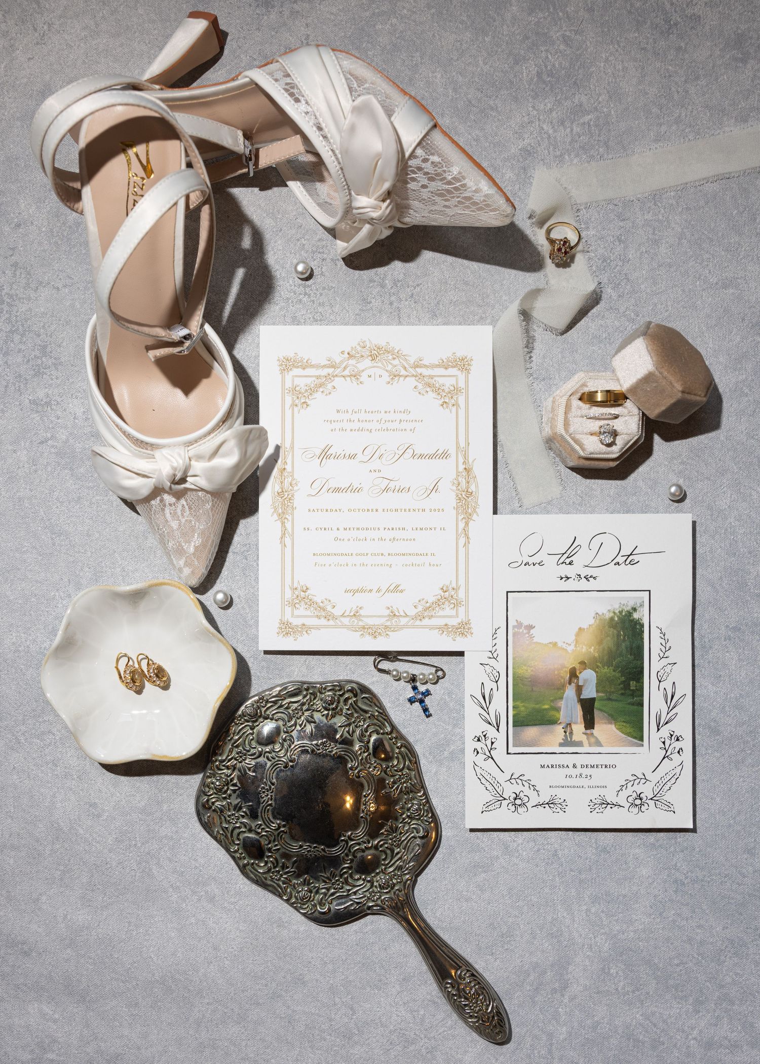 Wedding details flatlay with invitation, shoes, rings and vintage hand mirror.