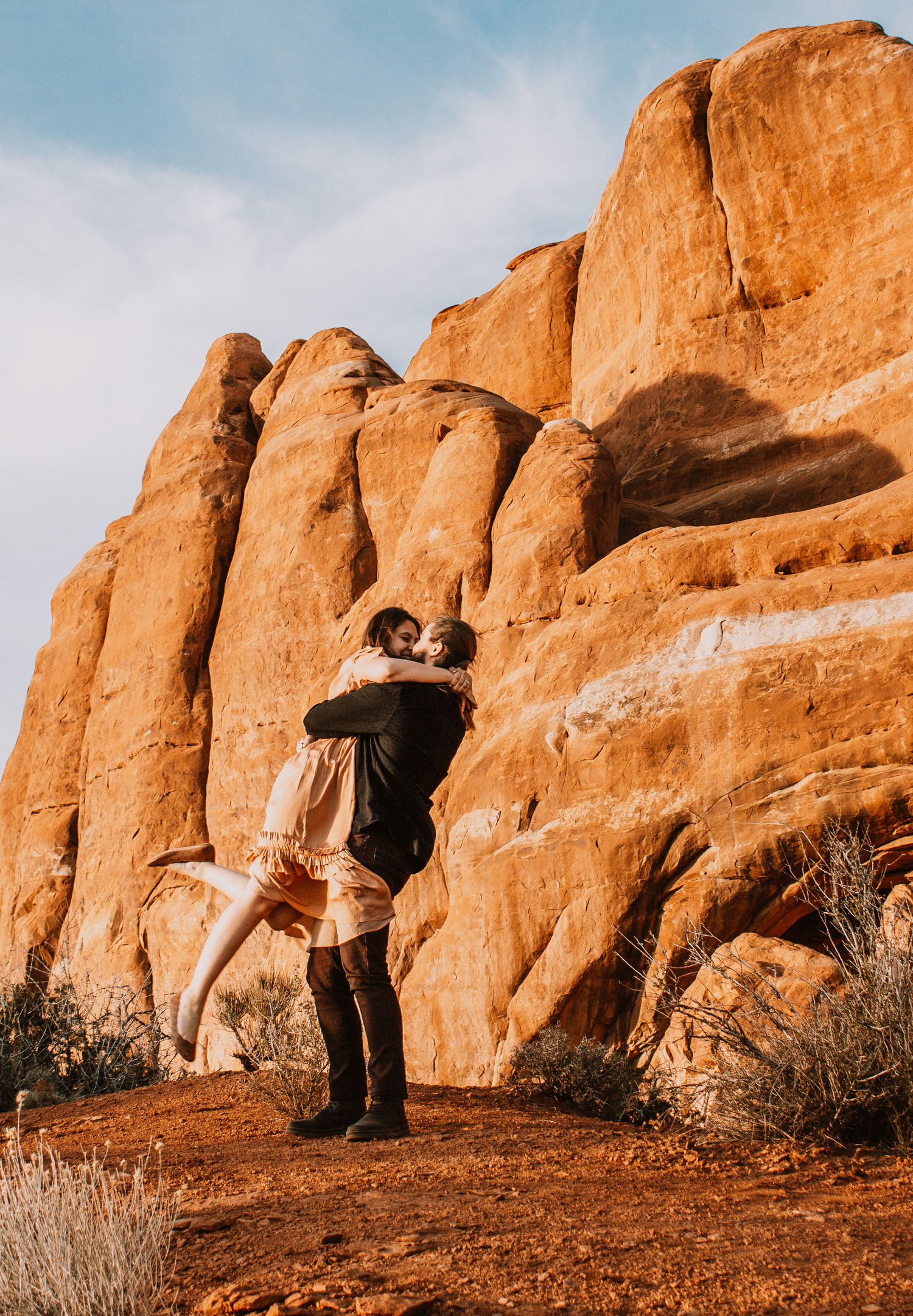 Couple portraits for engagement session in Moab, Utah, with beautiful red rocks background