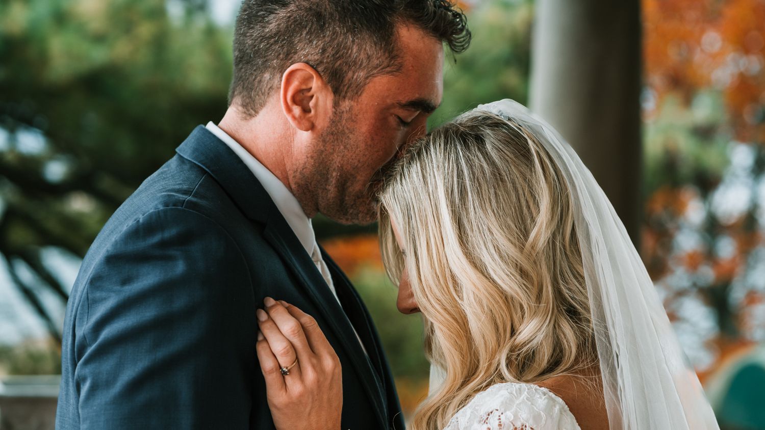 An intimate moment between newlyweds as they embrace during their wedding photoshoot.