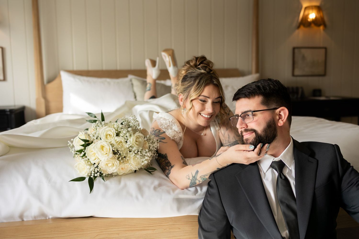Intimate wedding portraits in warm indoor lighting with soft natural window glow.