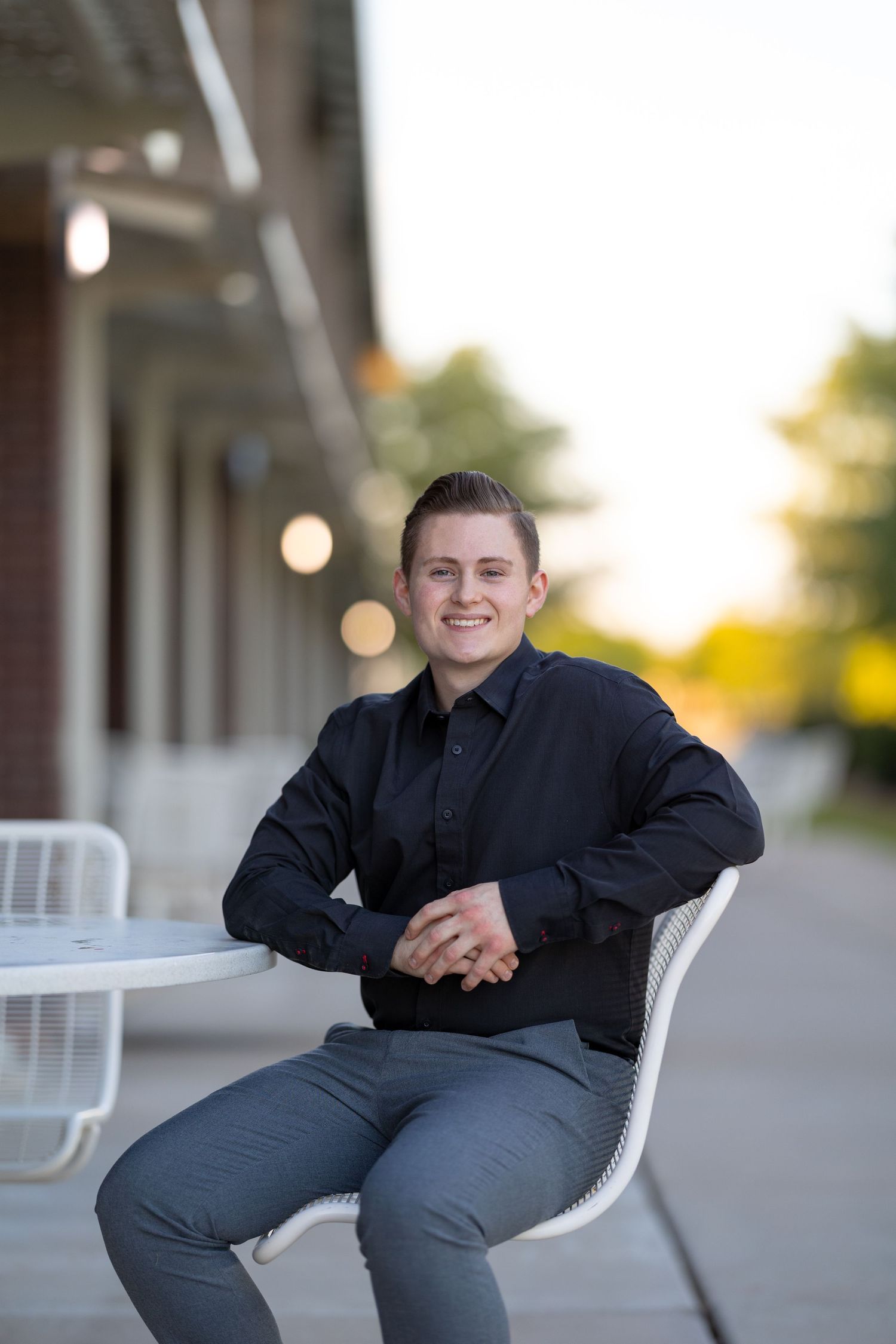 Jayden Sanford Photo business portrait sitting down.
