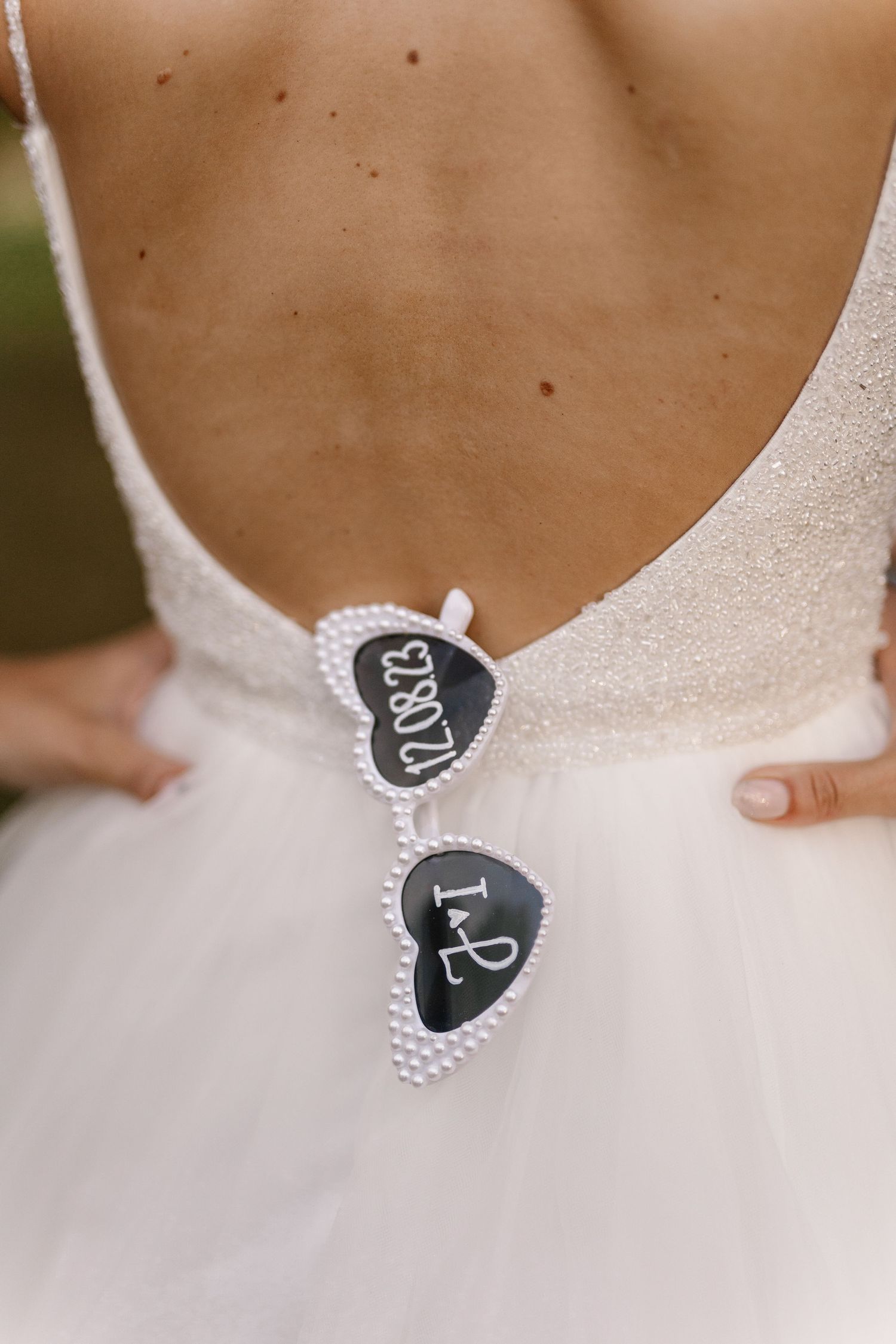 Close-up detail of a wedding dress back with decorative heart-shaped tags.