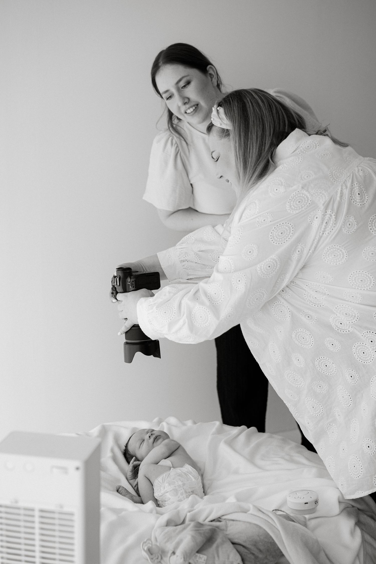 Photography session in progress with camera equipment and white decor.