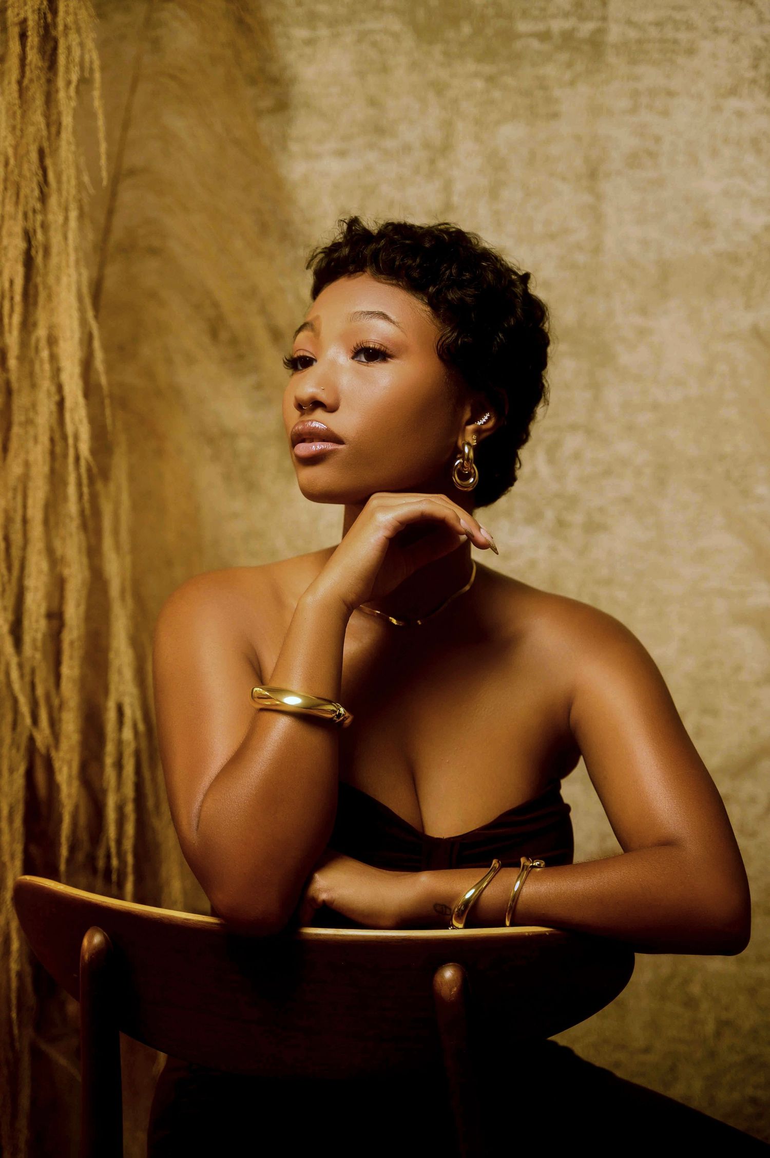 Artistic boudoir photography series with golden tones and dramatic lighting.