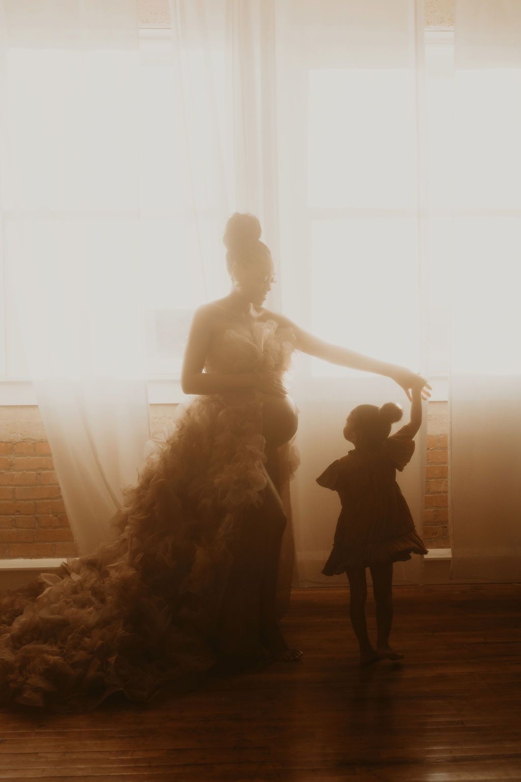 Silhouettes of two figures dance in a dreamy sepia-toned sequence against a bright window backdrop.