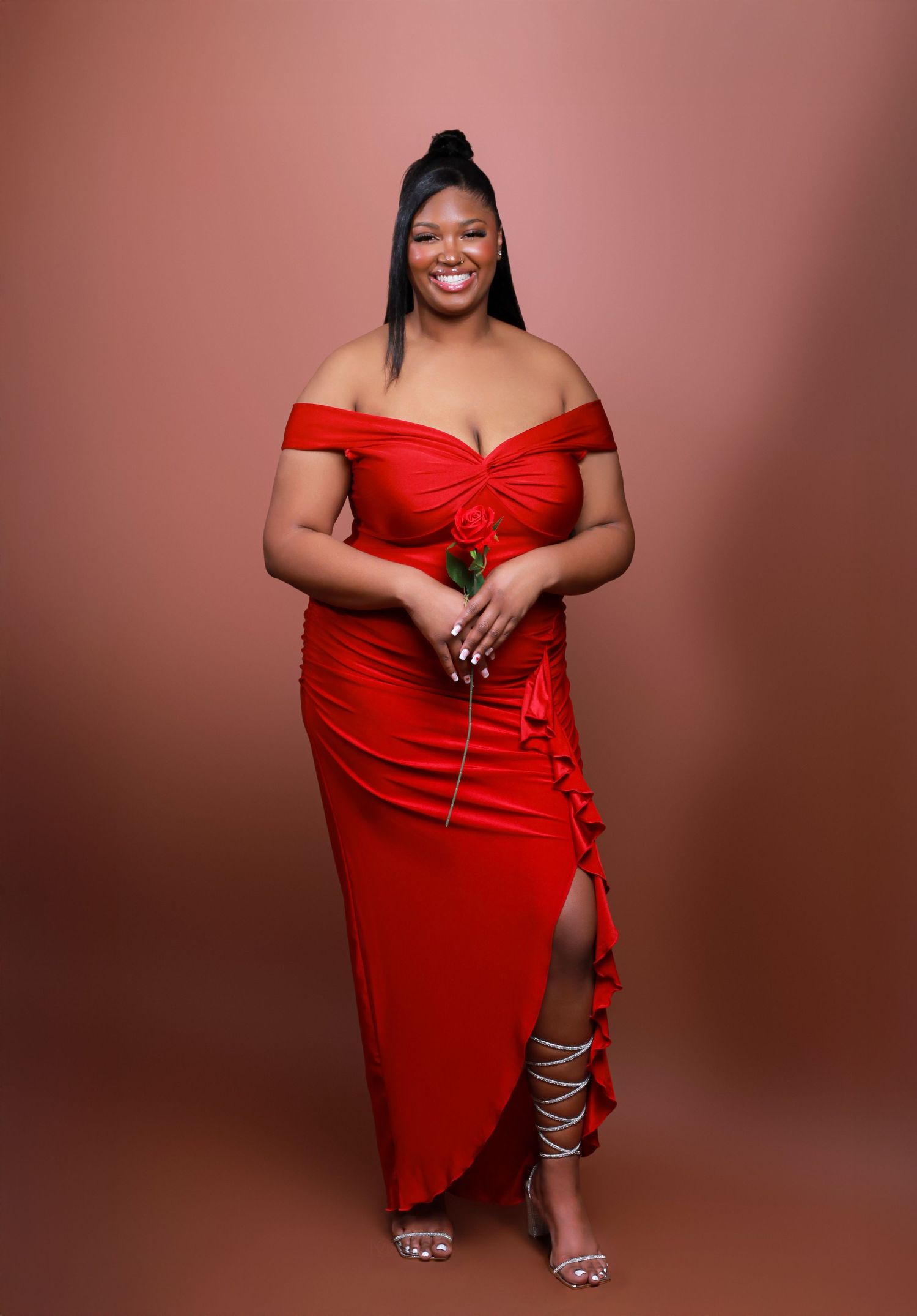 A series of glamour poses in a stunning red off-shoulder dress with a thigh-high slit against a brown backdrop.