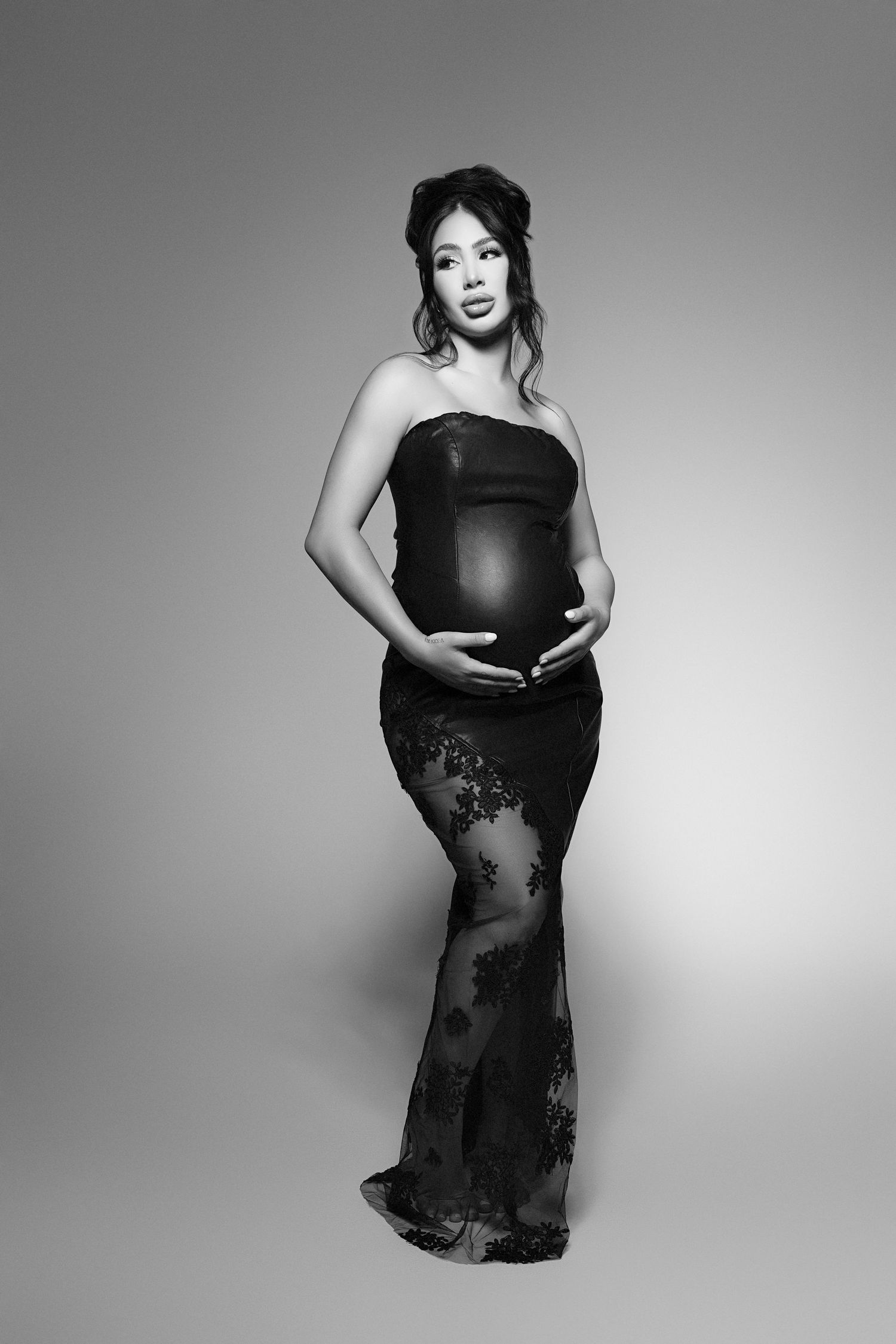 A black and white photo of a pregnant woman