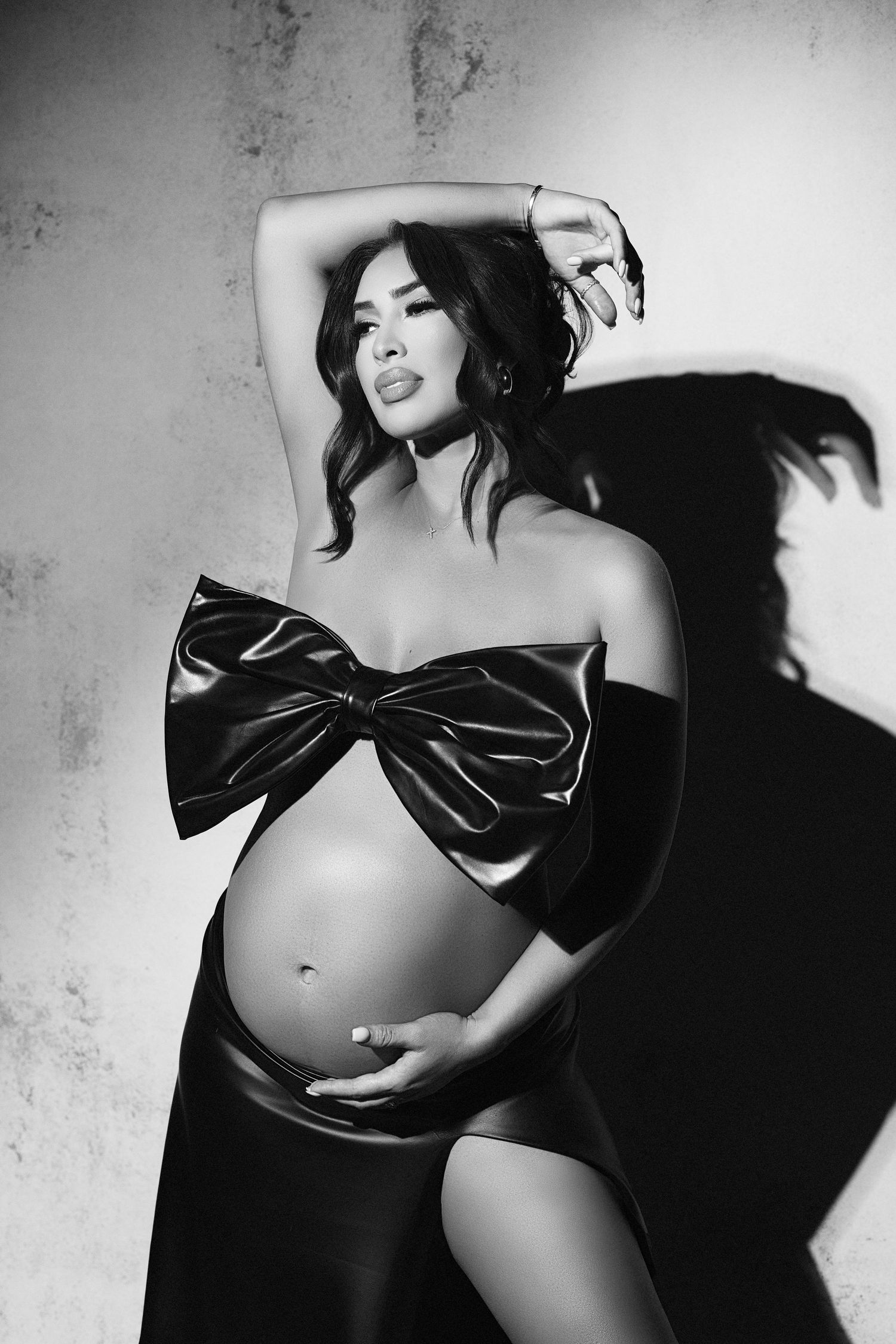 A black and white photo of a pregnant woman