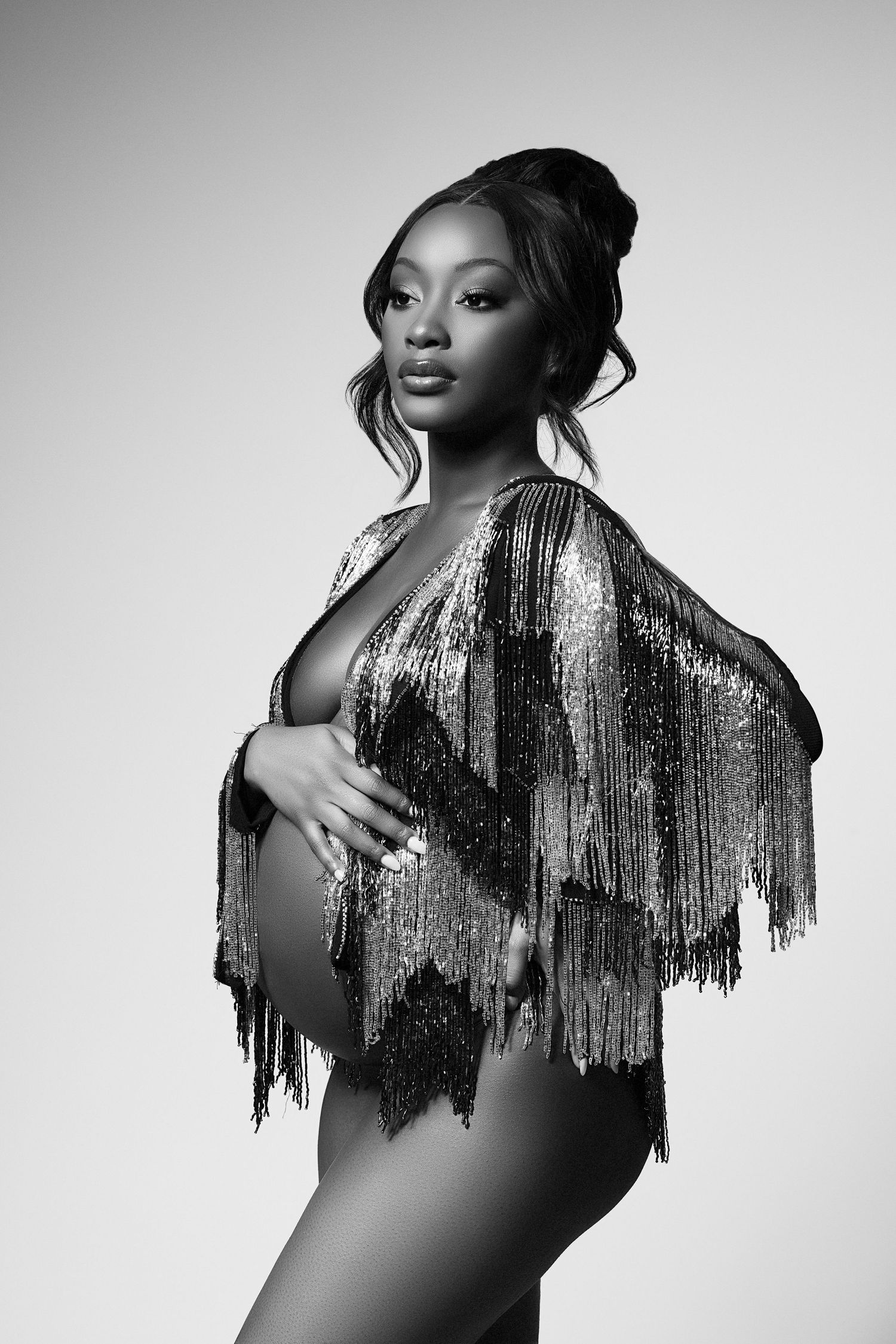 A black and white photo of a pregnant woman
