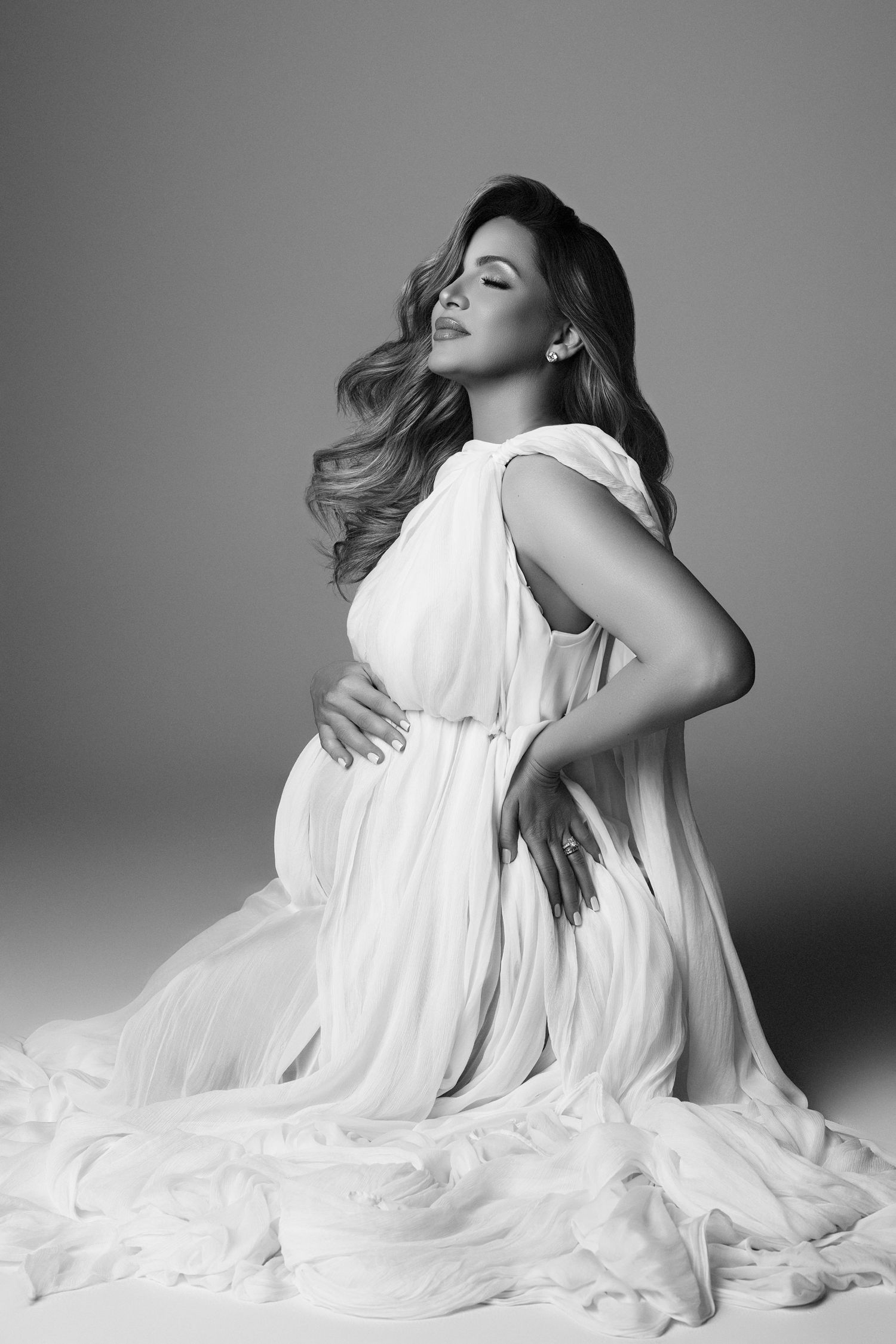 A black and white photo of a pregnant woman