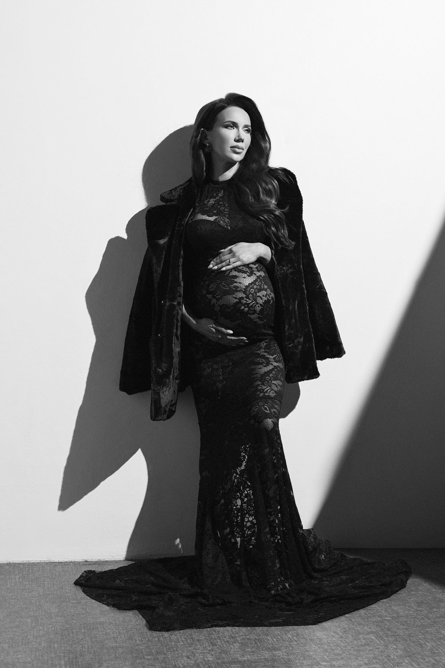 A black and white photo of a pregnant woman