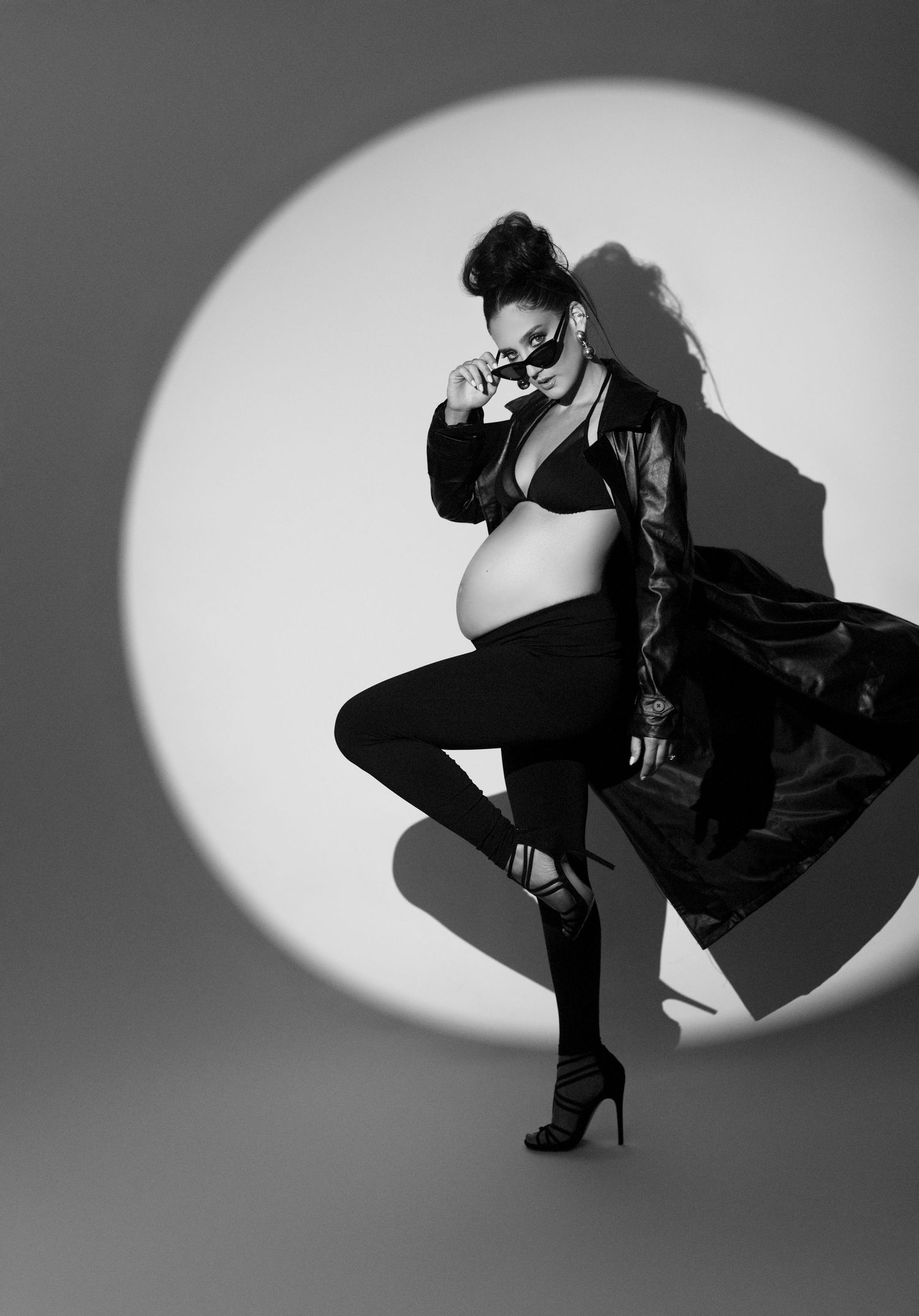 A black and white photo of a pregnant woman