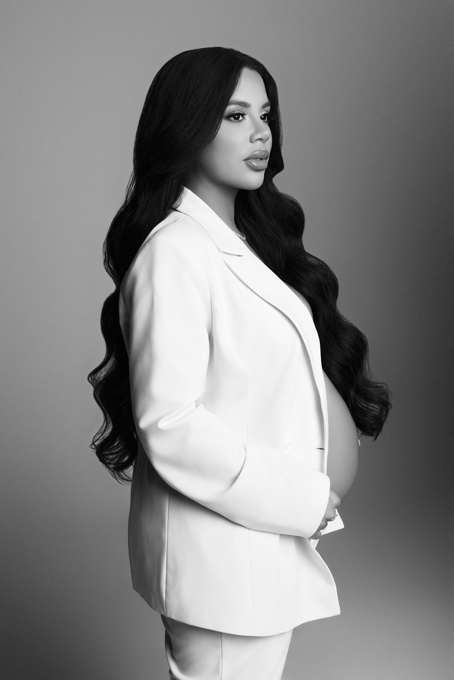 A black and white photo of a pregnant woman