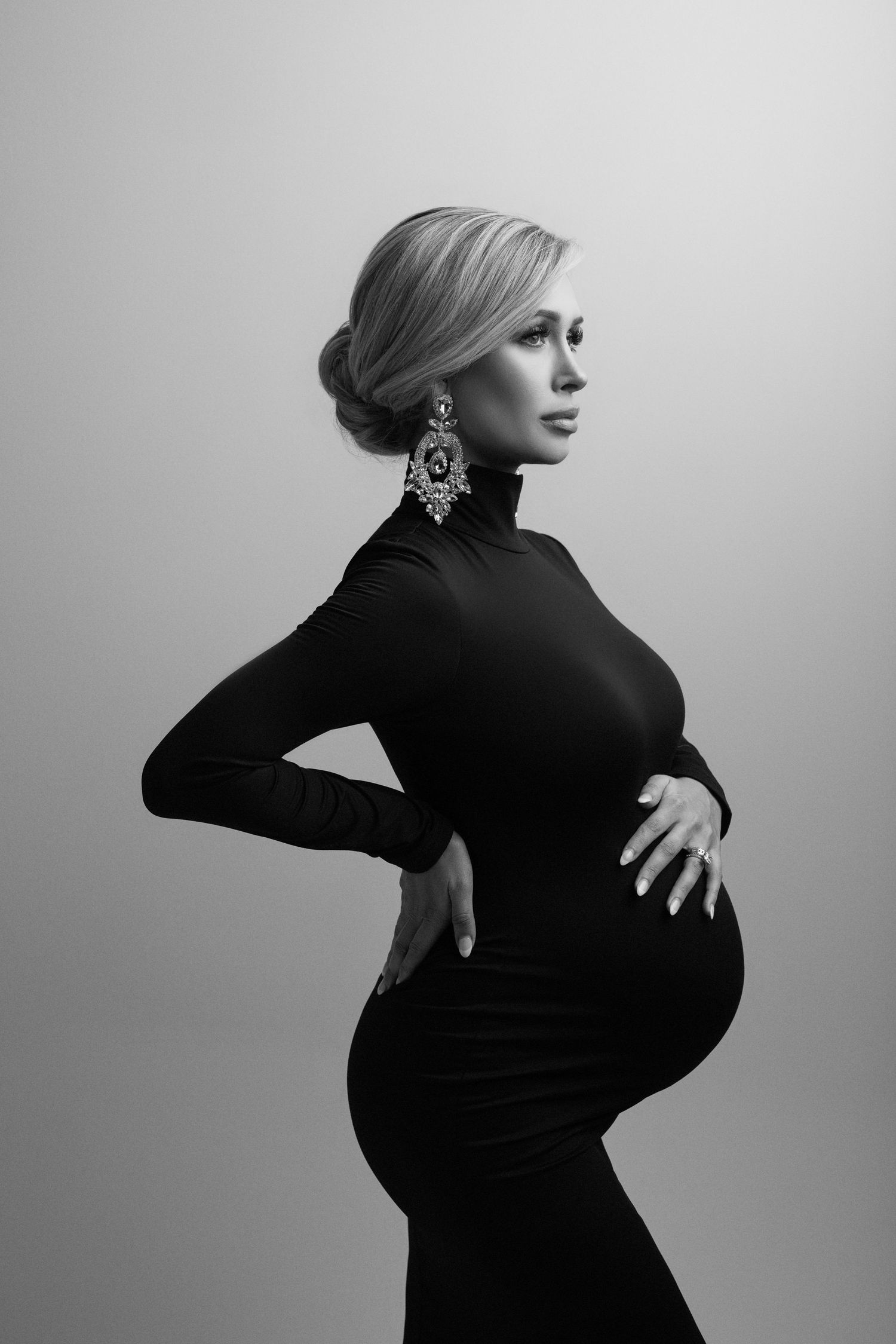 A black and white photo of a pregnant woman