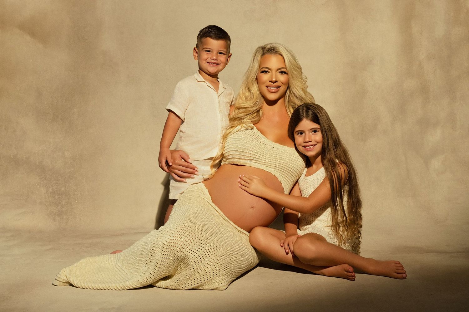 A photo of a pregnant woman with her two children