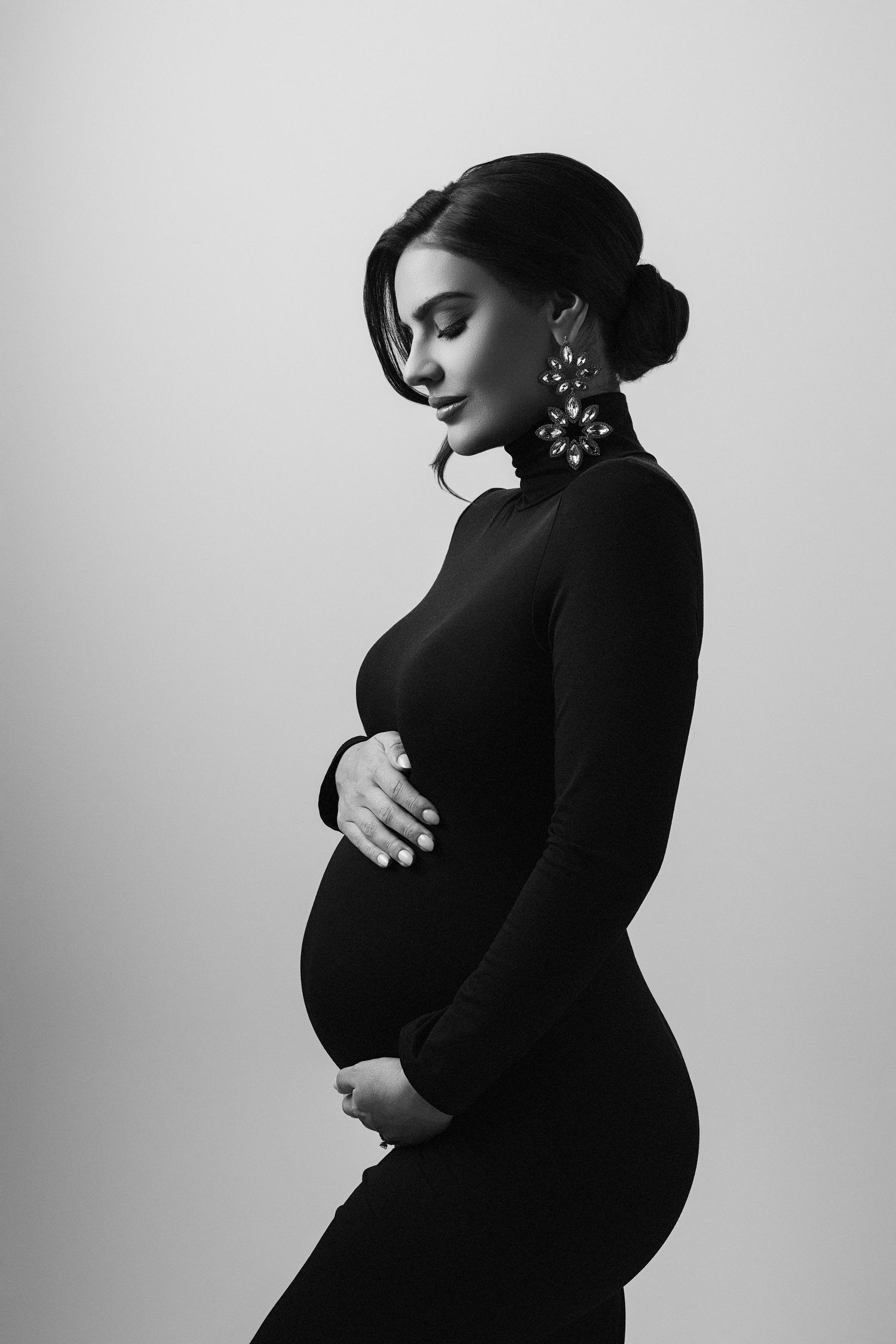 A black and white photo of a pregnant woman