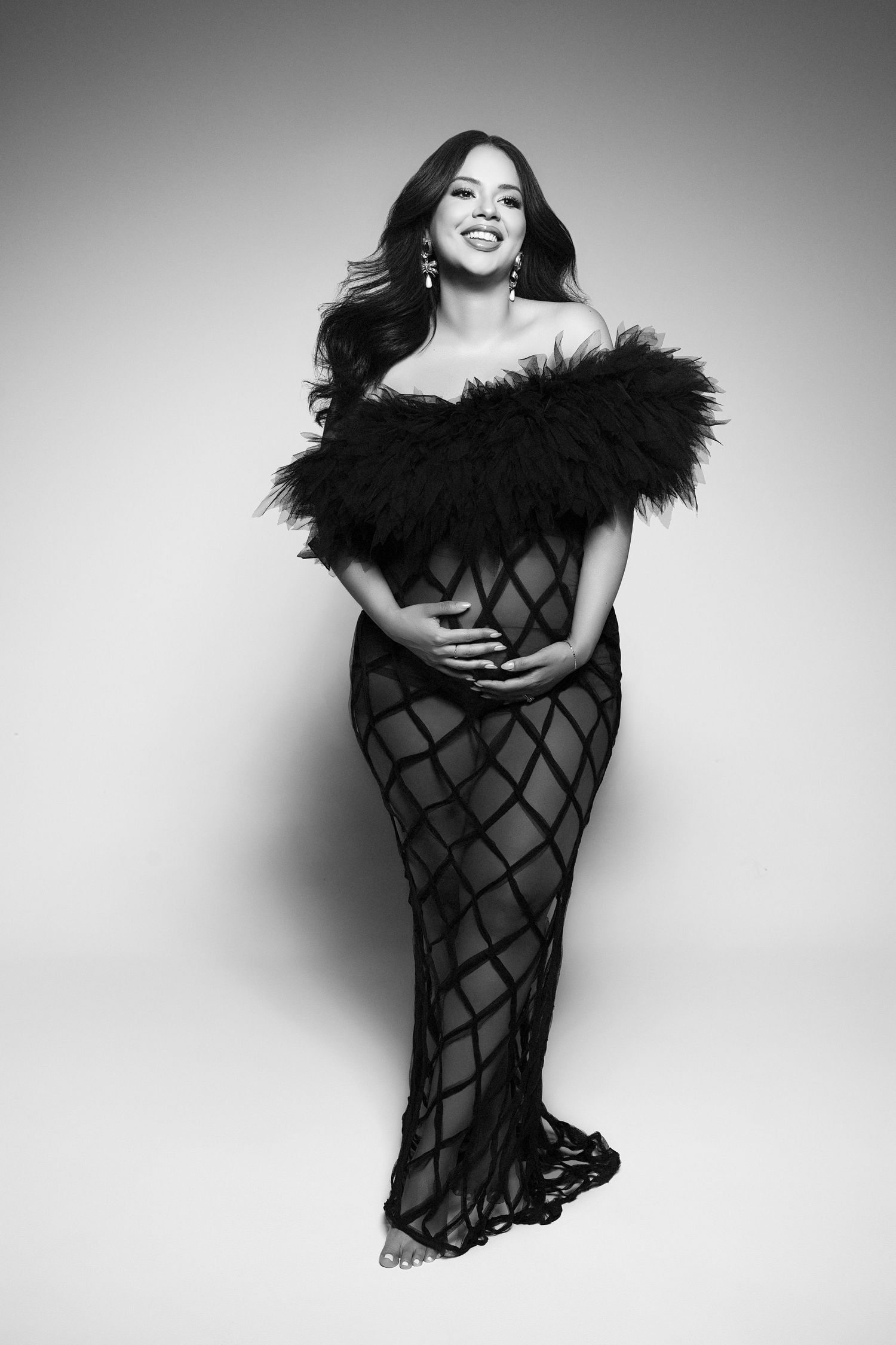 A black and white photo of a pregnant woman