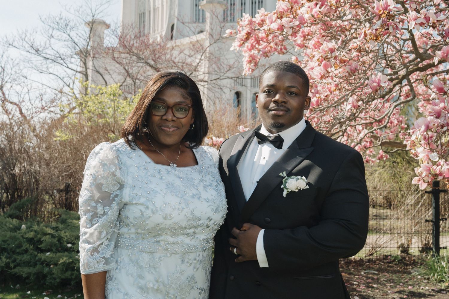 Mother of the groom and groom posing at the Baháʼí House of Worship during a bright spring wedding in Wilmette, IL.