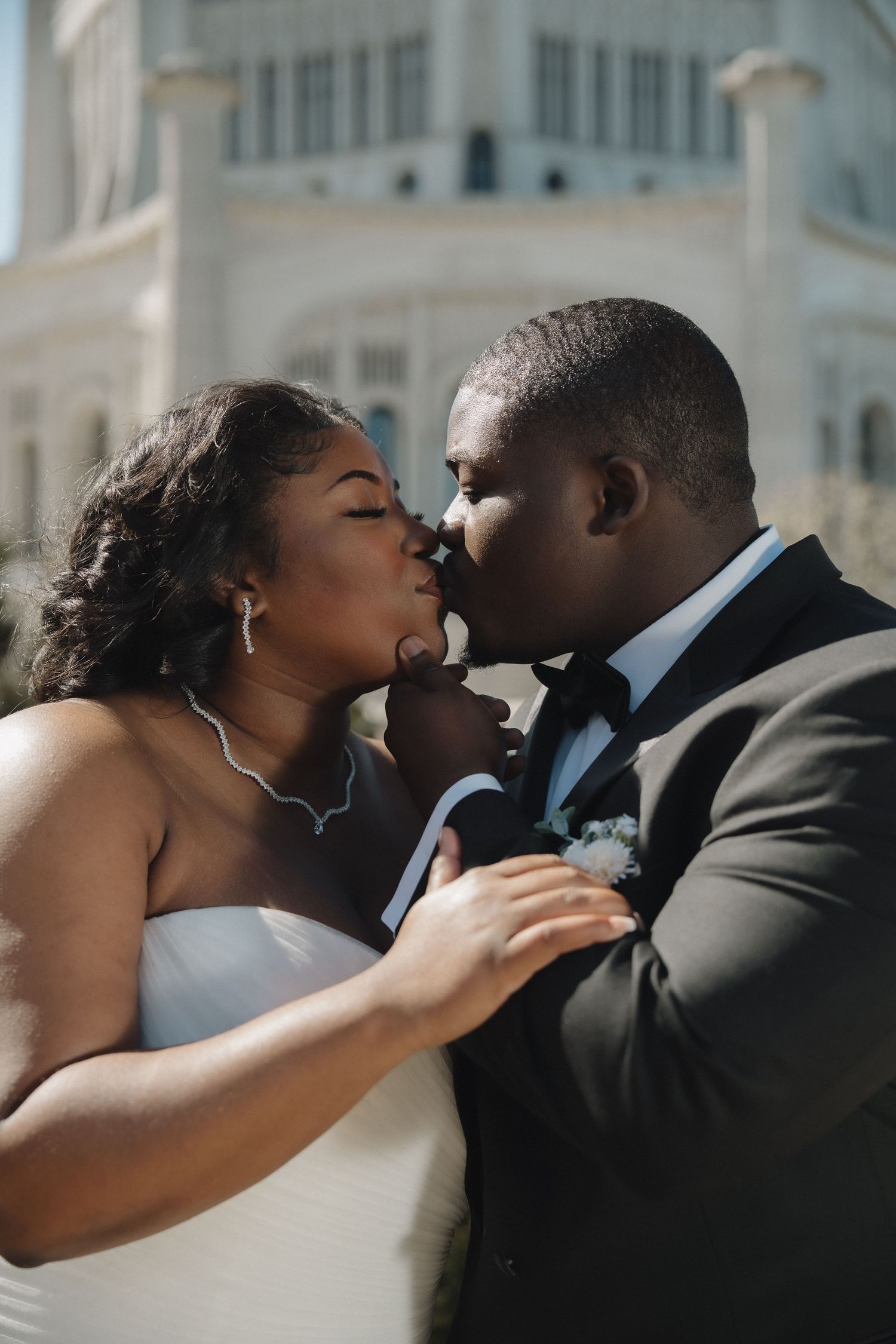 Authentic wedding storytelling by Salt & Mist Co., featuring a romantic kiss between a bride and groom during their spring celebration.