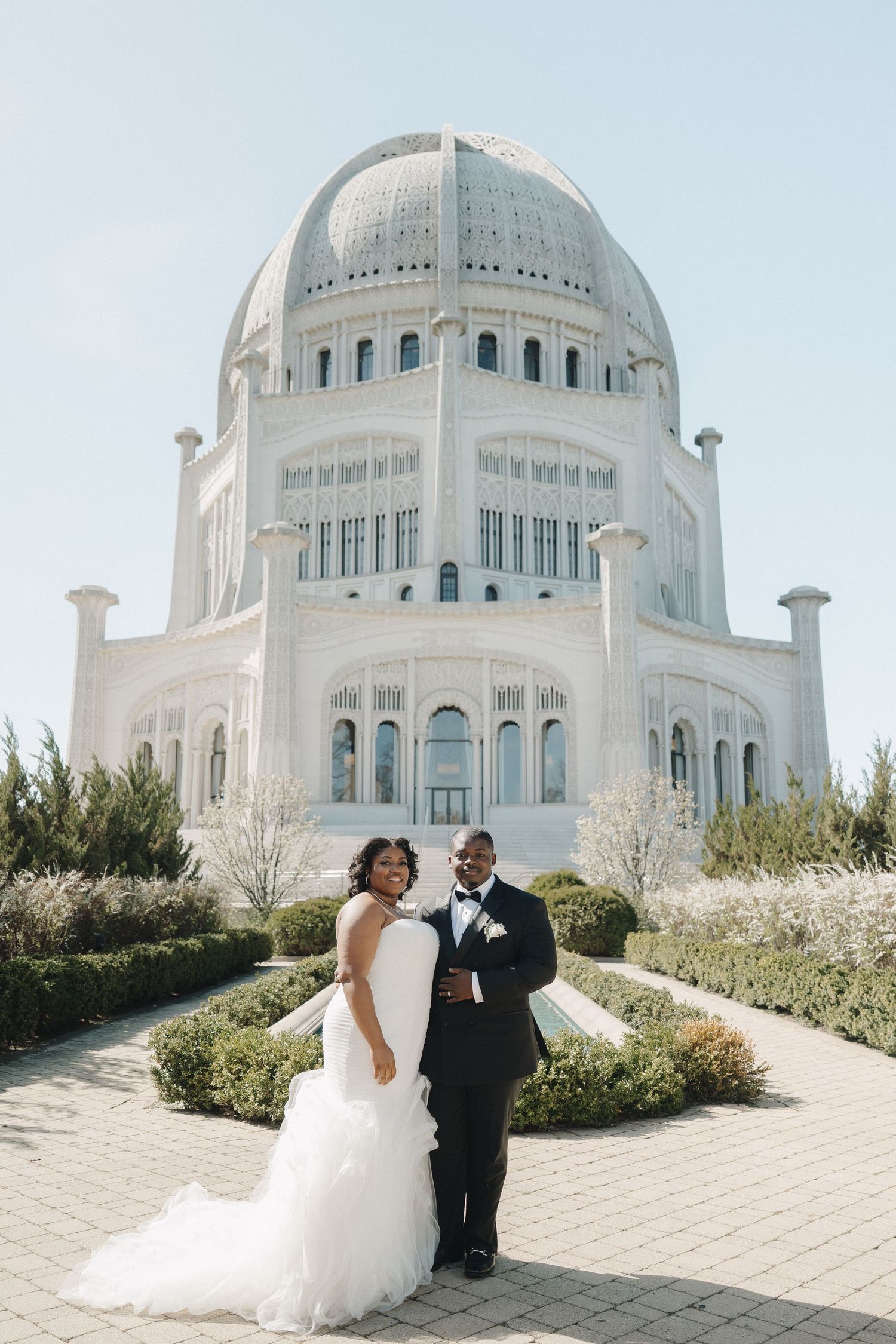 Bride and groom posing in front of the Bahai Temple in Wilmette, Illinois on their wedding day.