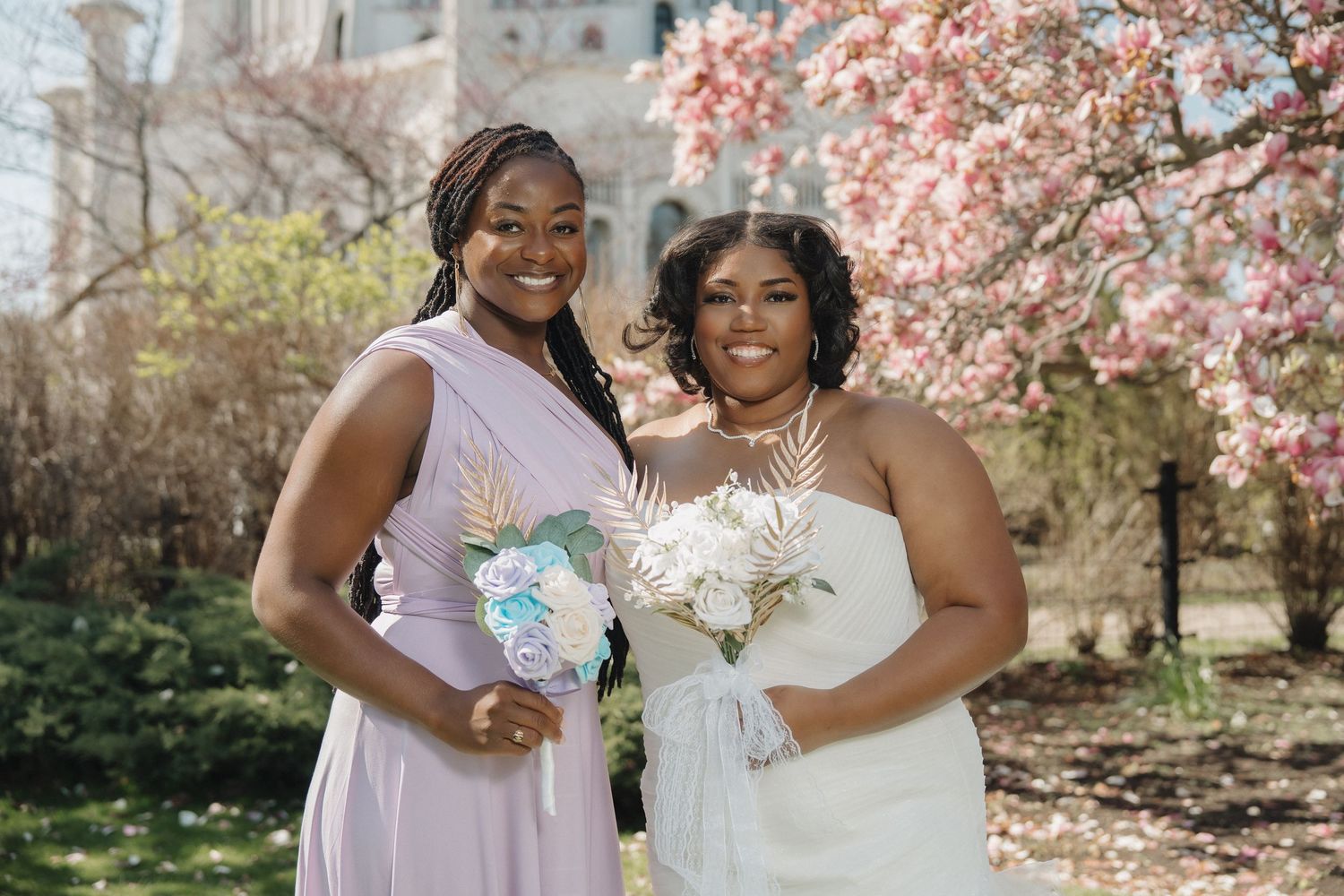 A bride and bridesmaid pose during their spring outdoor wedding at the Baháʼí House of Worship in Wilmette, IL.