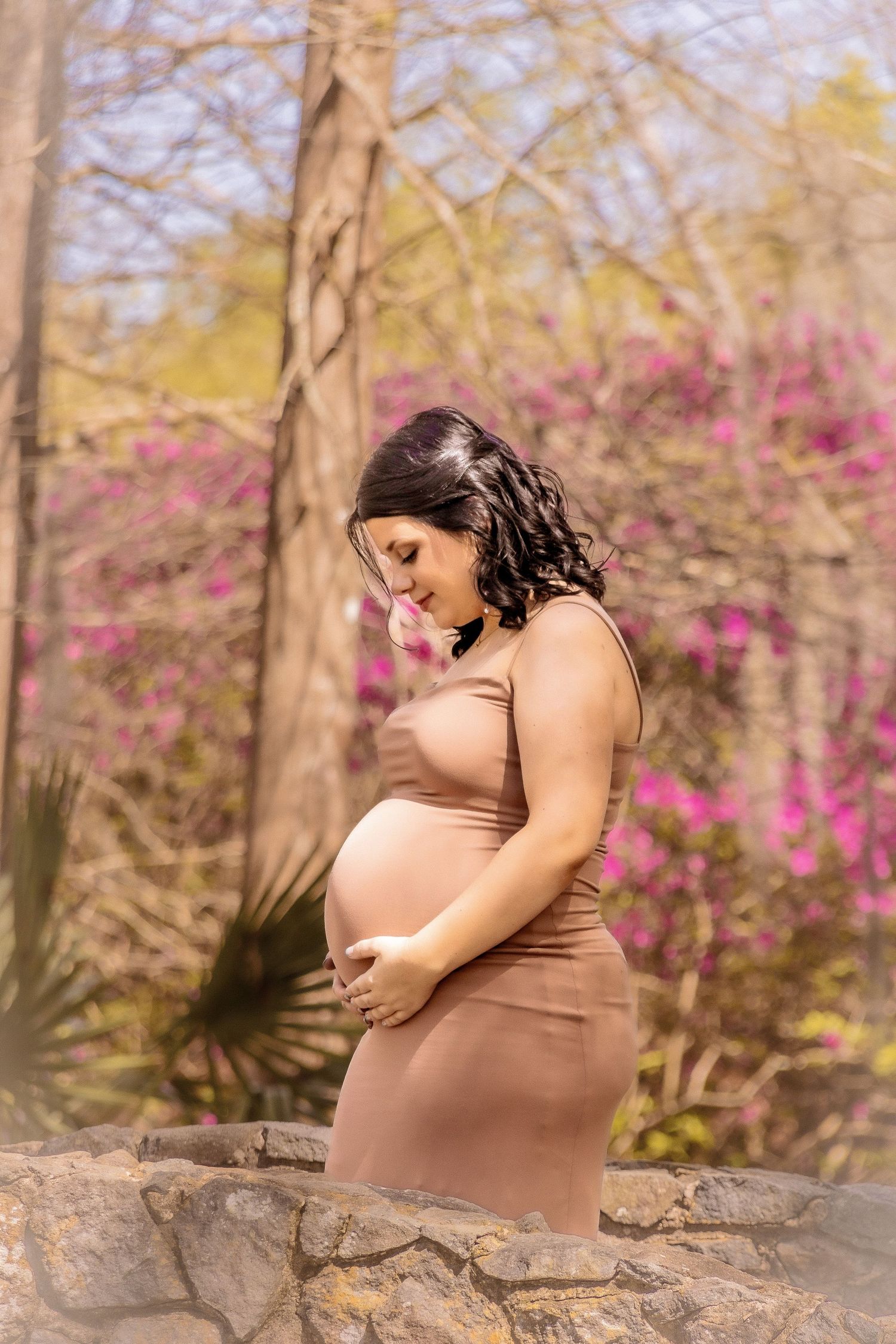 Maternity photo sequence showing a pregnant woman in brown dress against a backdrop of pink flowers and trees.