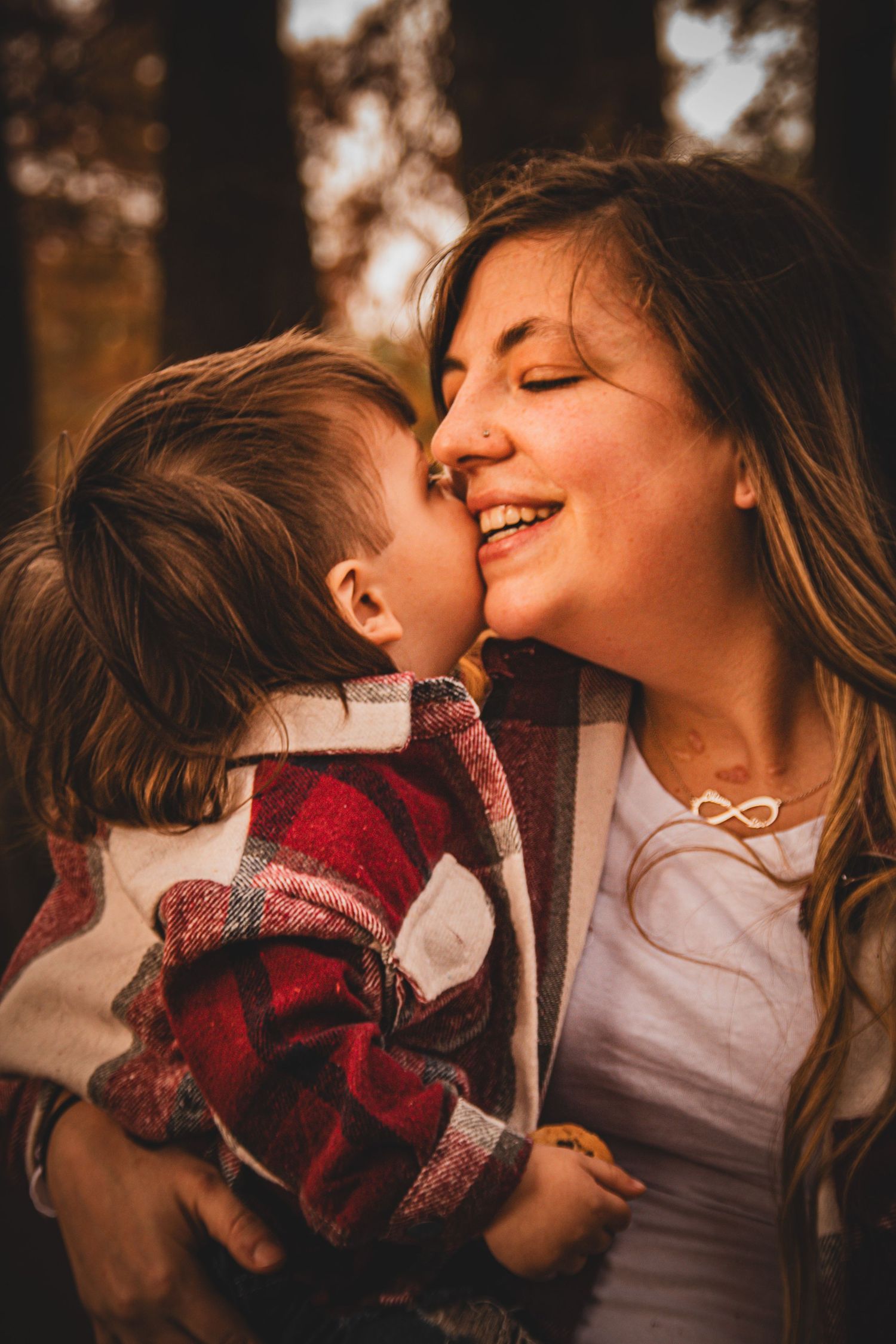 Intimate lifestyle portraits in warm evening light with cozy plaid scarf.