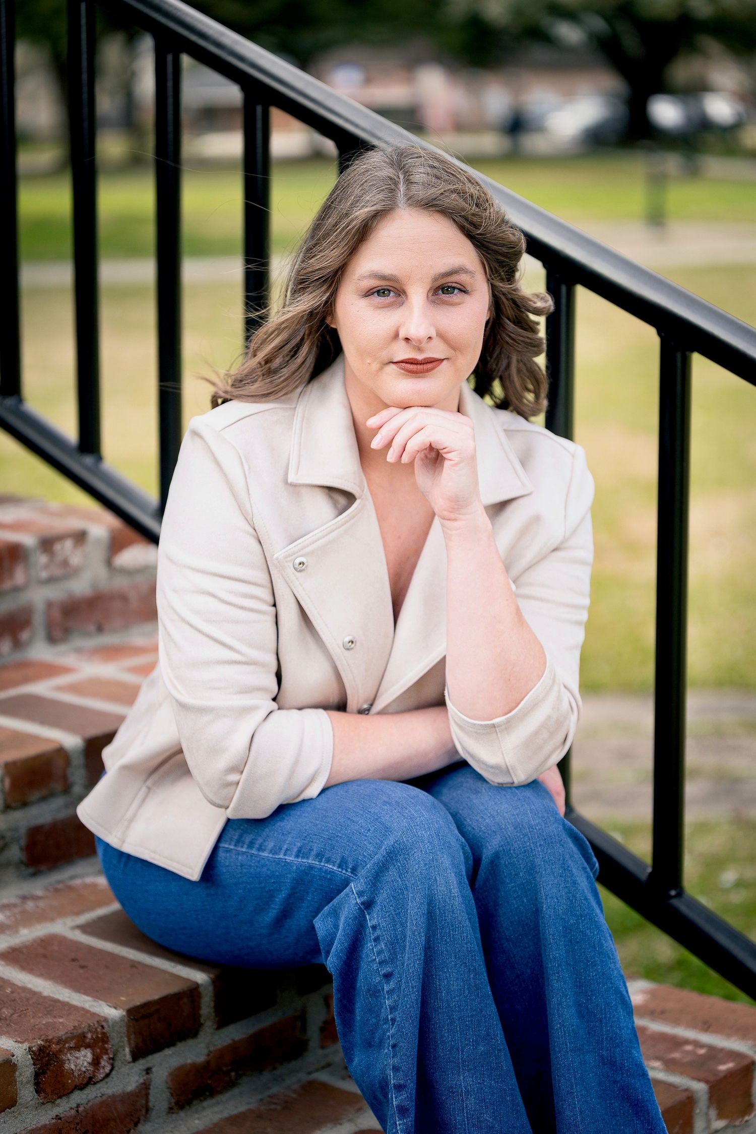 Casual portrait series on brick steps with iron railing in natural outdoor lighting.