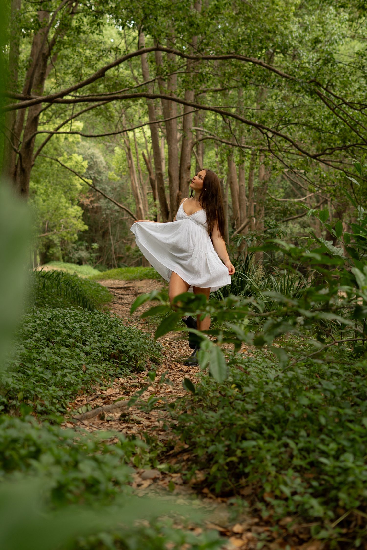Solo creative portrait of girl in white dress in a forest setting, lush greenery surrounding - Photos by Bailey Rose Gold Coast