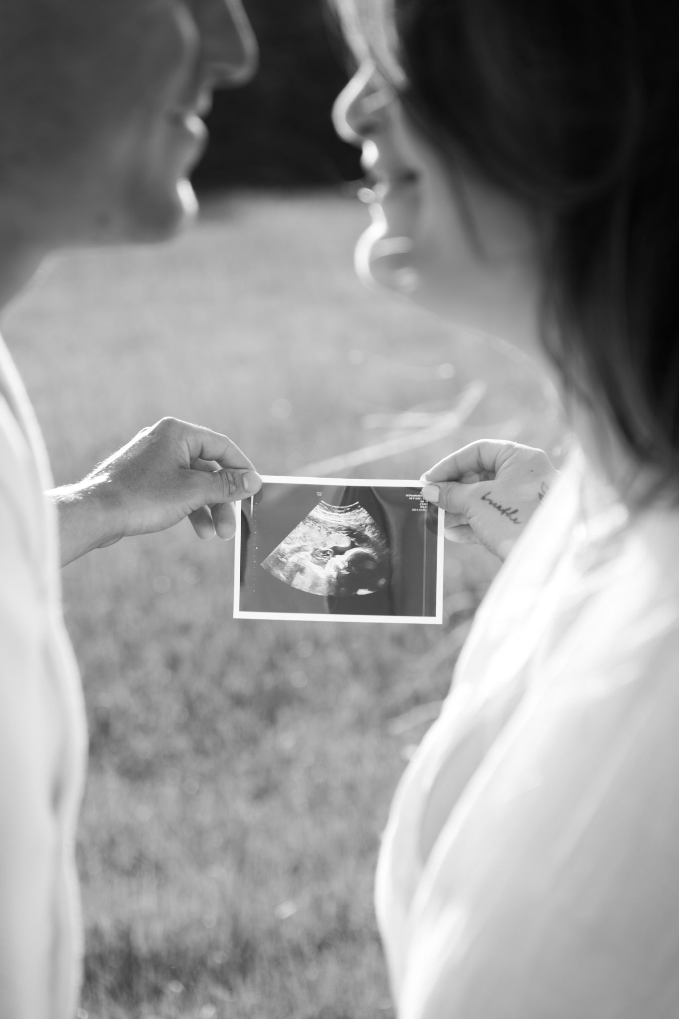 Black and white close up looking through couple to maternity picture - Photos by Bailey Rose Gold Coast