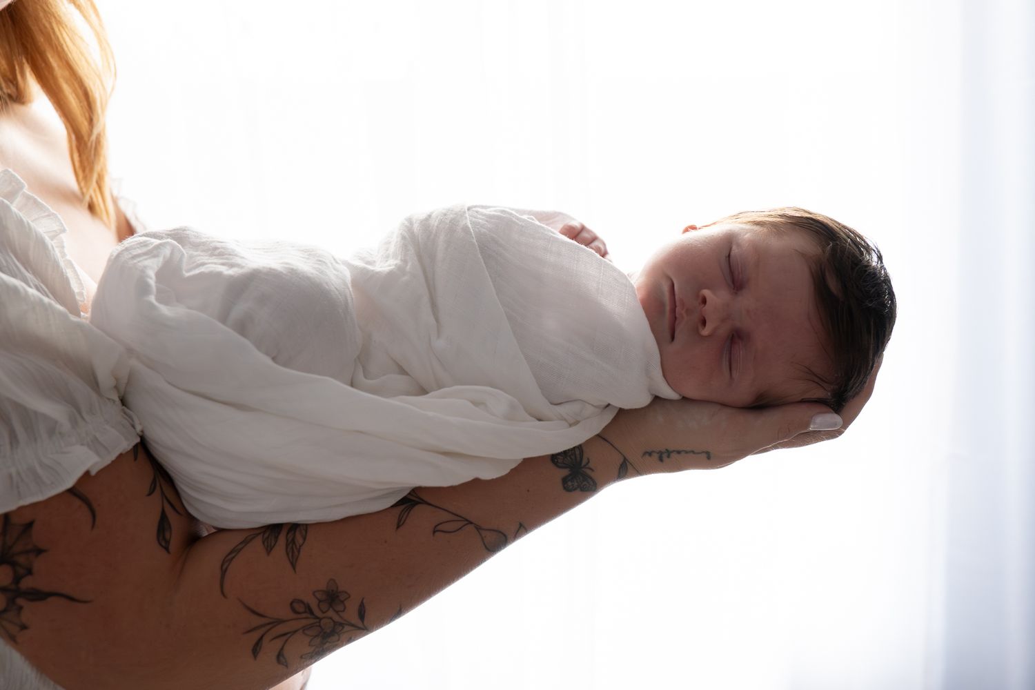 Sleeping newborn wrapped in white natural light in home session — Photos by Bailey Rose Gold Coast