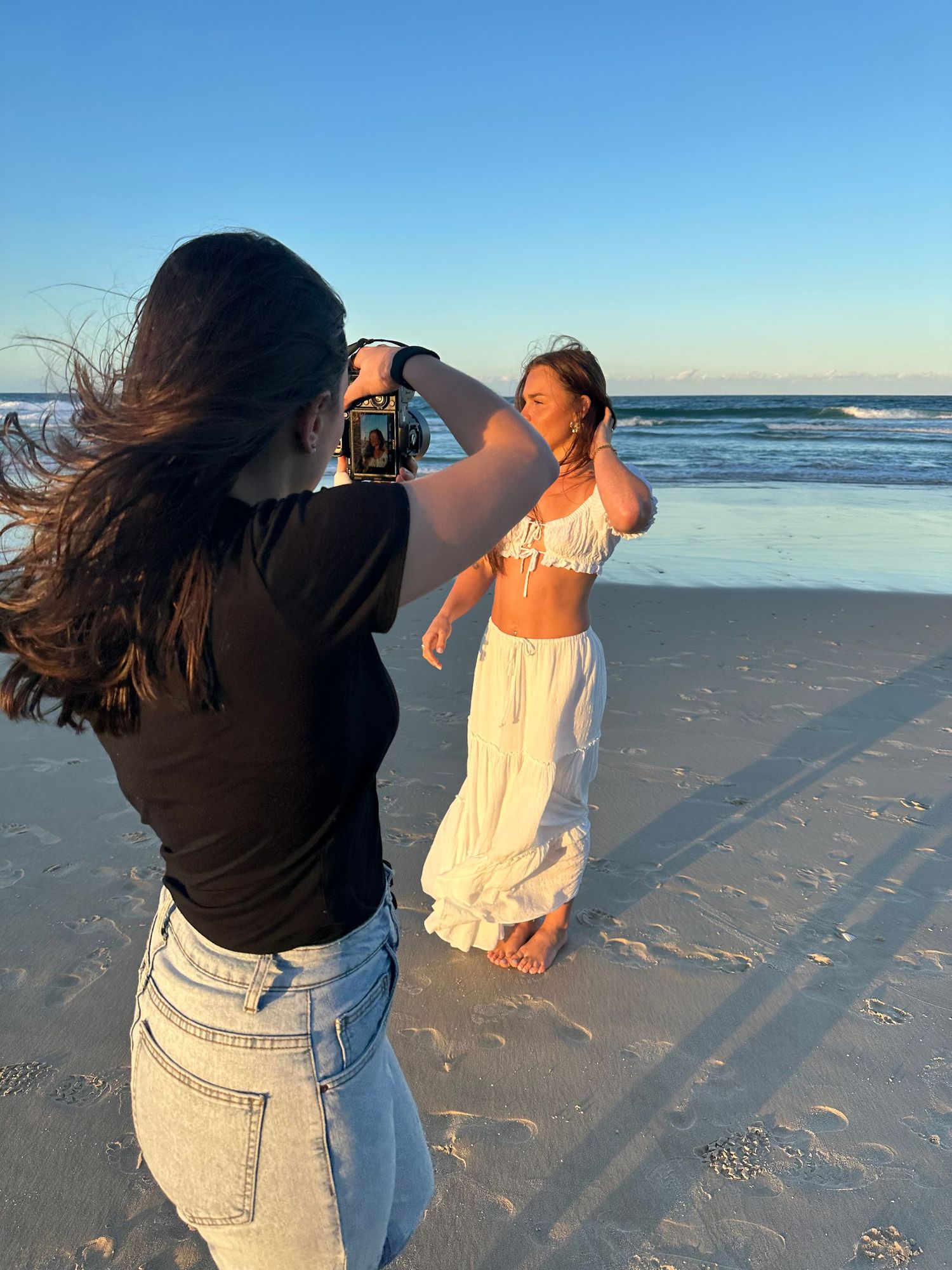 Photographer taking photos of solo portrait session during golden hour on the beach - Photos by Bailey Rose Gold Coast