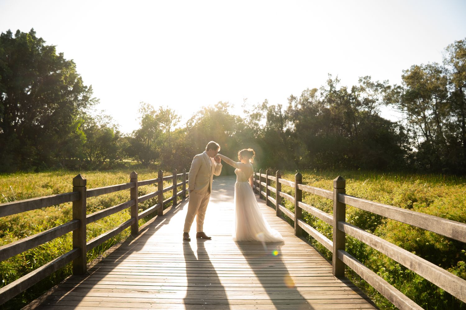 Couple during elopement session at golden hour on a timber bridge — Photos by Bailey Rose Brisbane