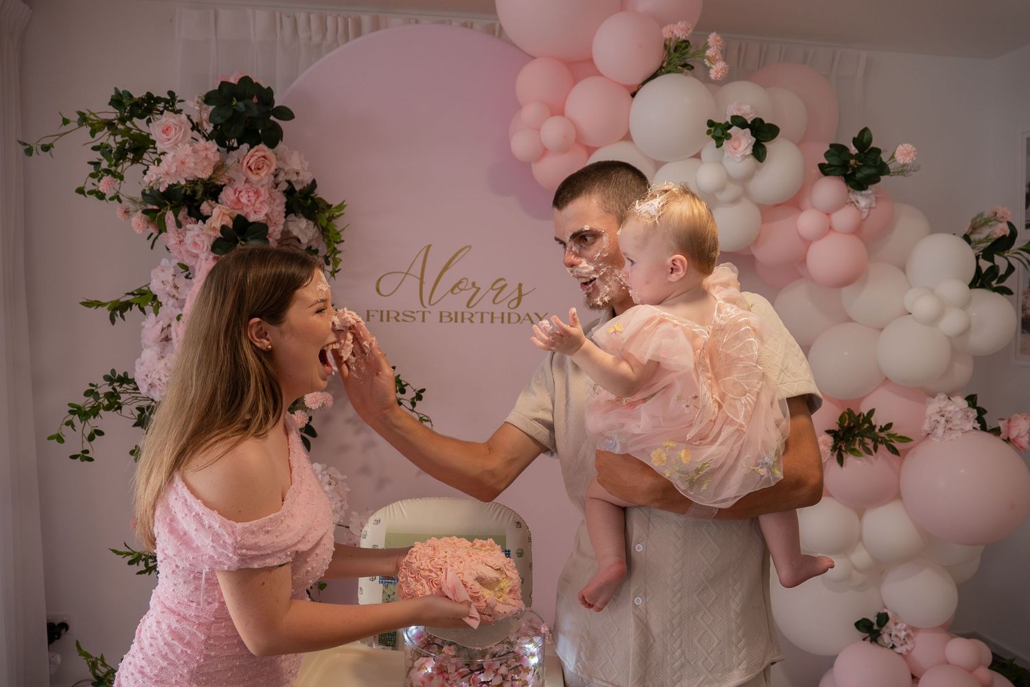 Event photography of a first birthday party, mother and father participating in cake smash laughing - Photos by Bailey Rose Gold Coast