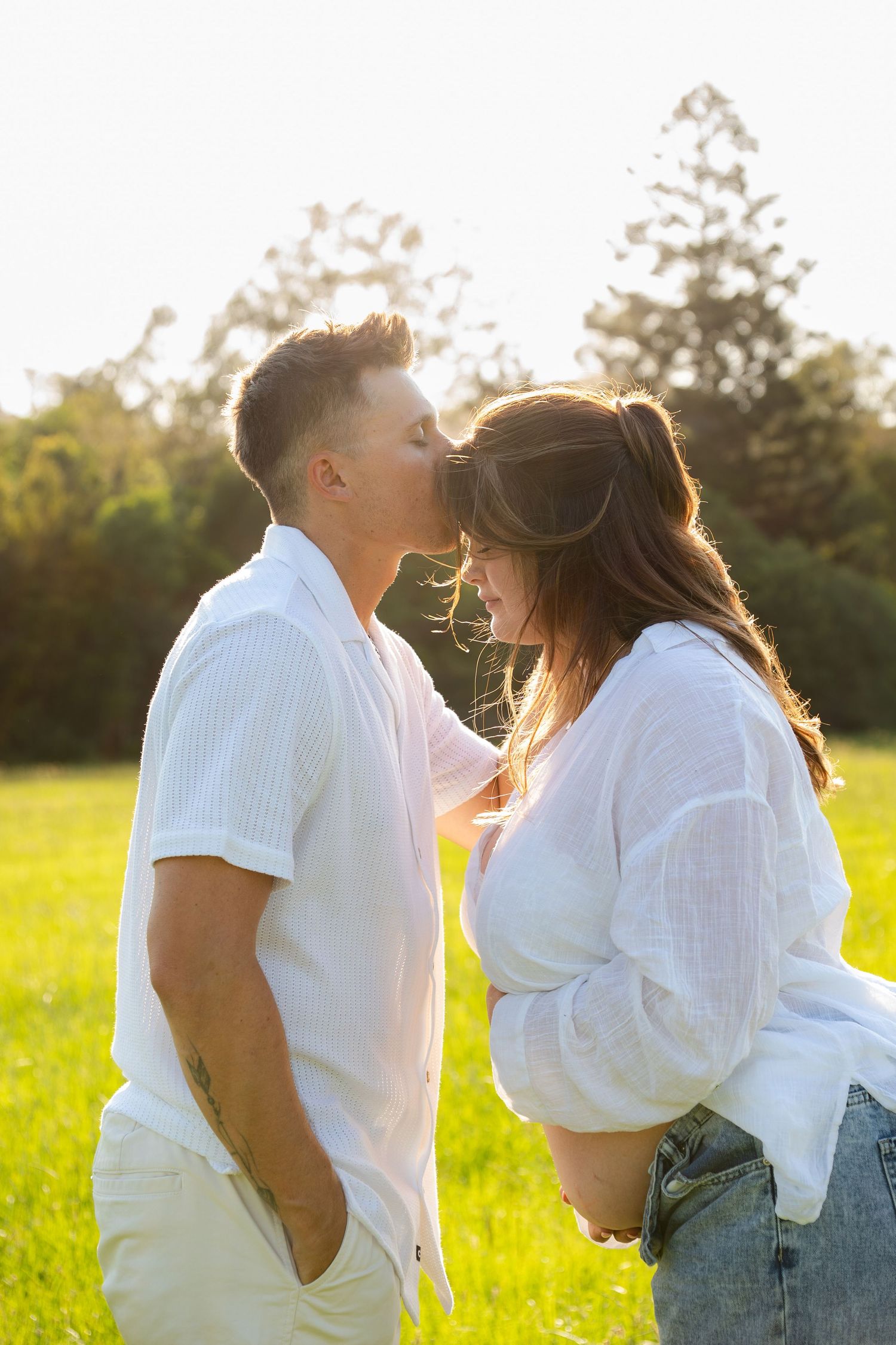 Couple kissing forehead Maternity golden hour in open field - Photos by Bailey Rose Gold Coast