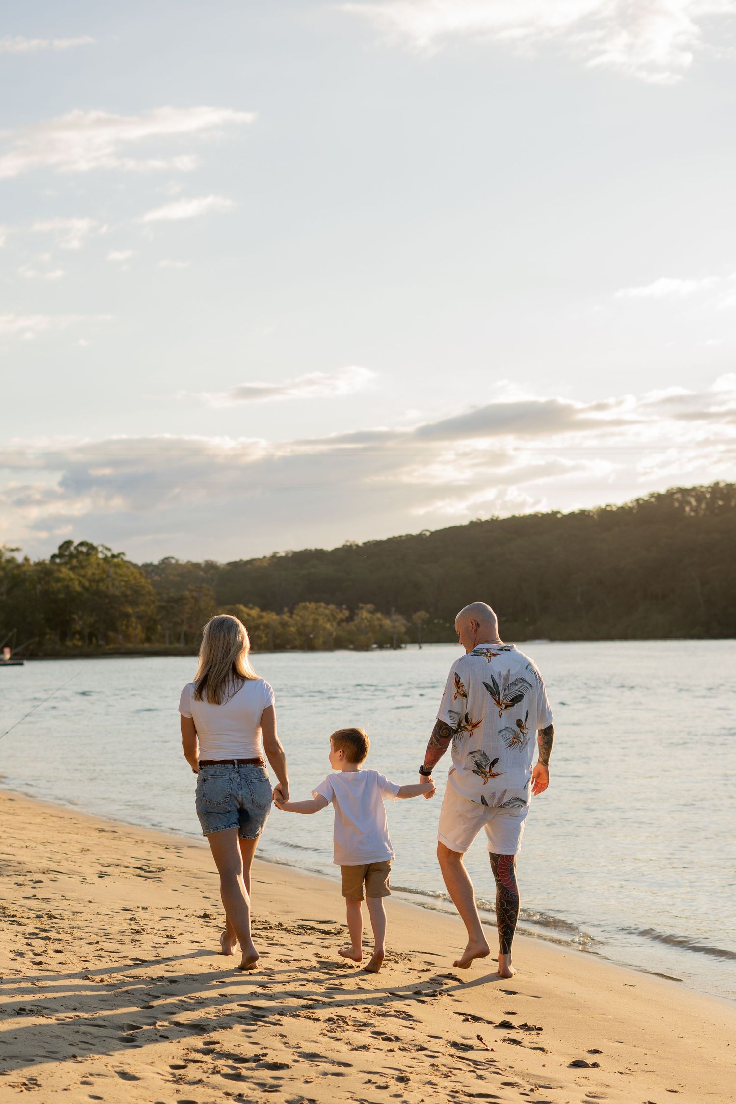 Family walking together on beach at golden hour — Photos by Bailey Rose Gold Coast