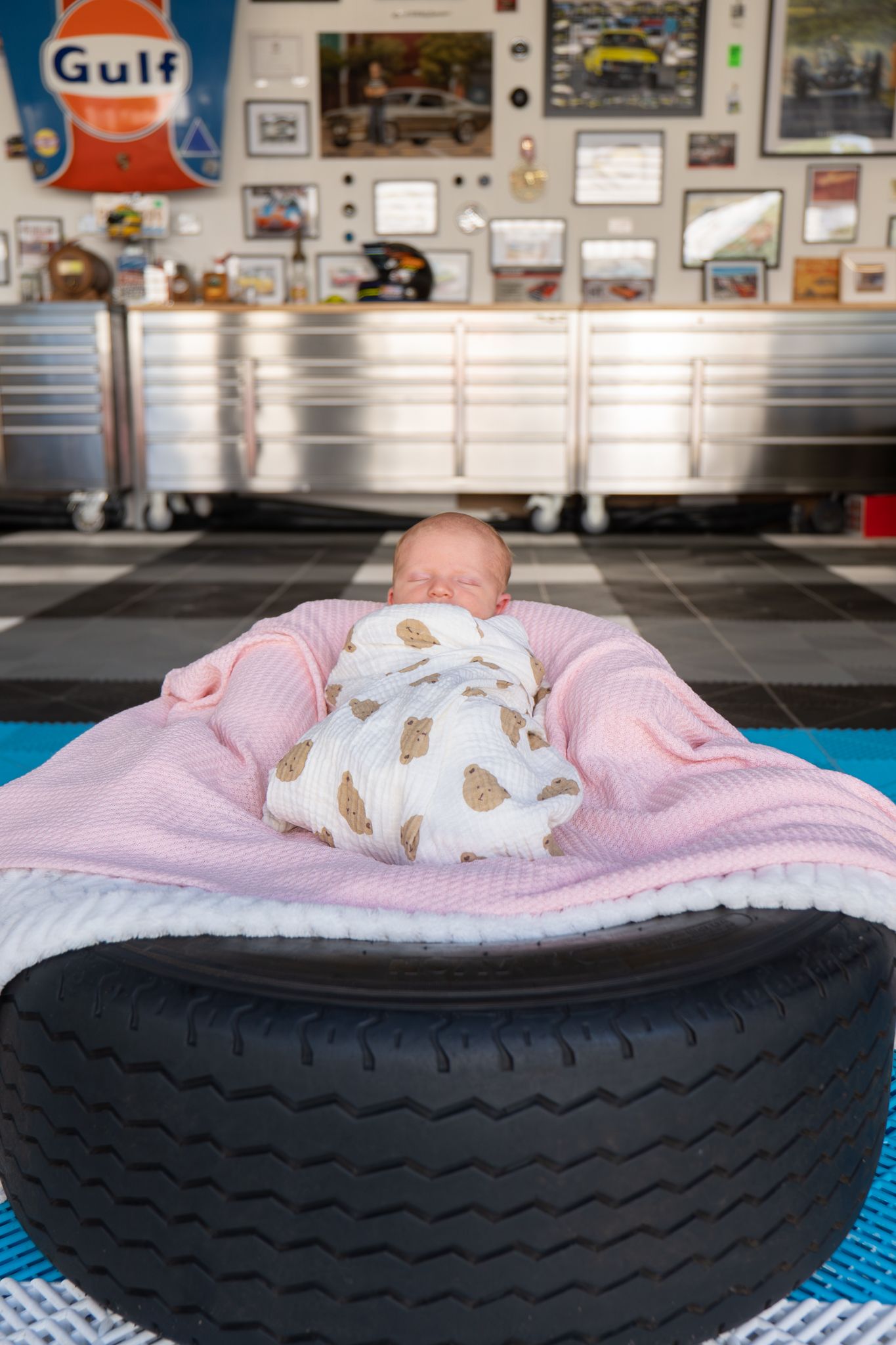 Newborn posed on top of race car tyre during in home session — Photos by Bailey Rose Brisbane