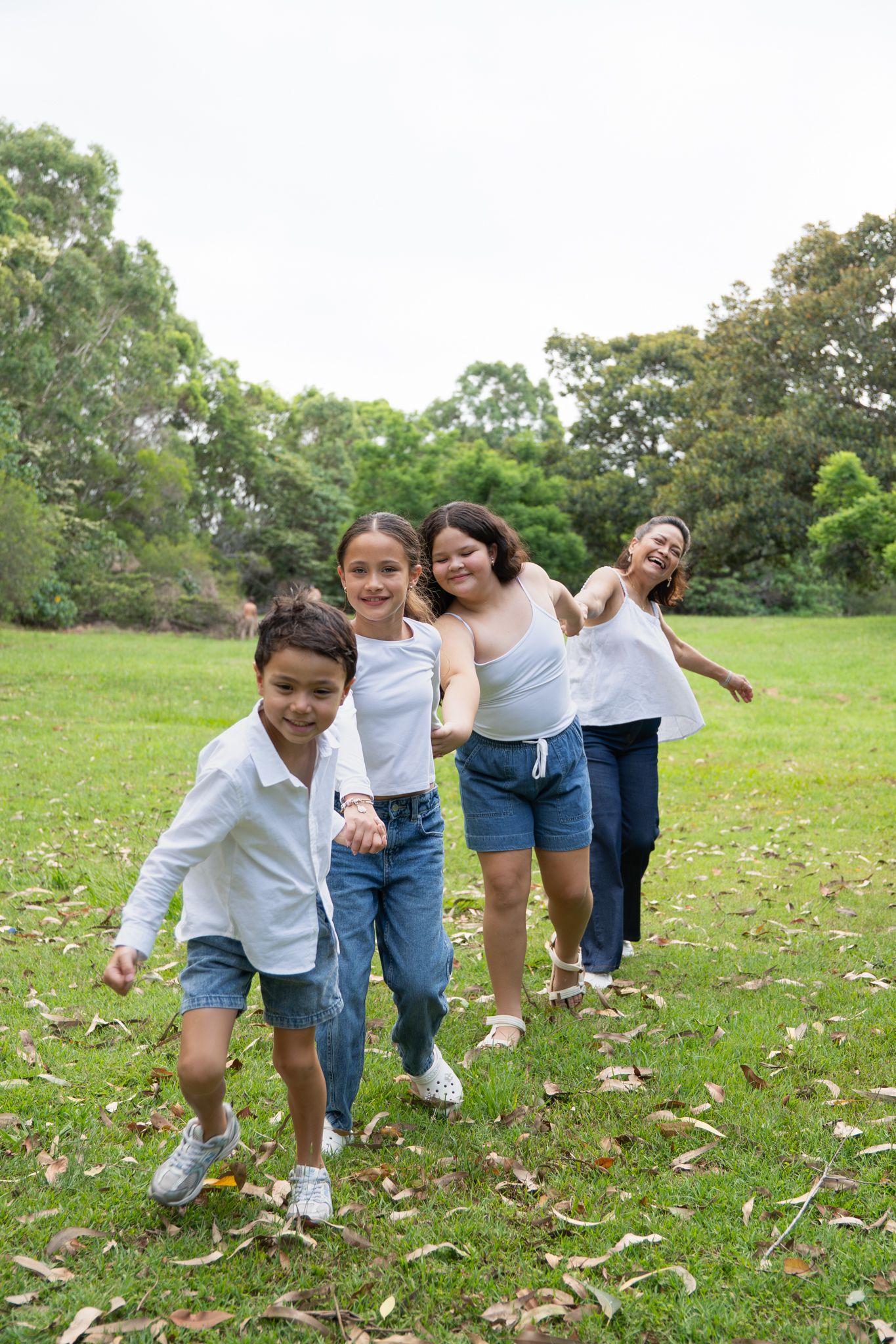 Family of four laughing together in natural light — Photos by Bailey Rose Brisbane
