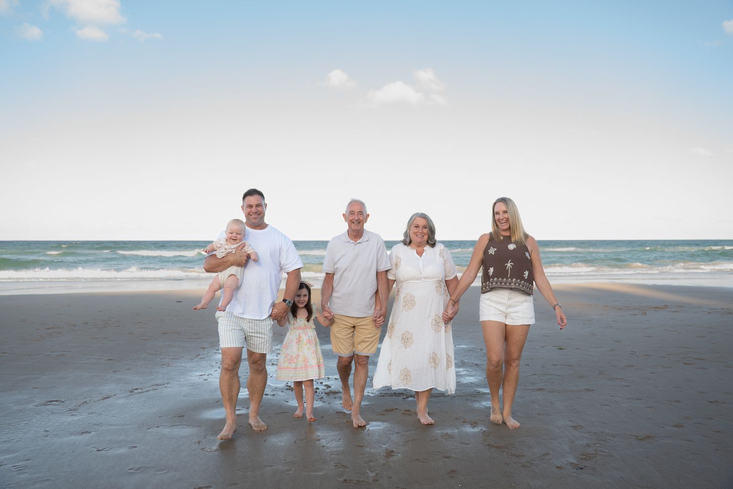 Family walking together on beach at golden hour with grandparents — Photos by Bailey Rose Gold Coast