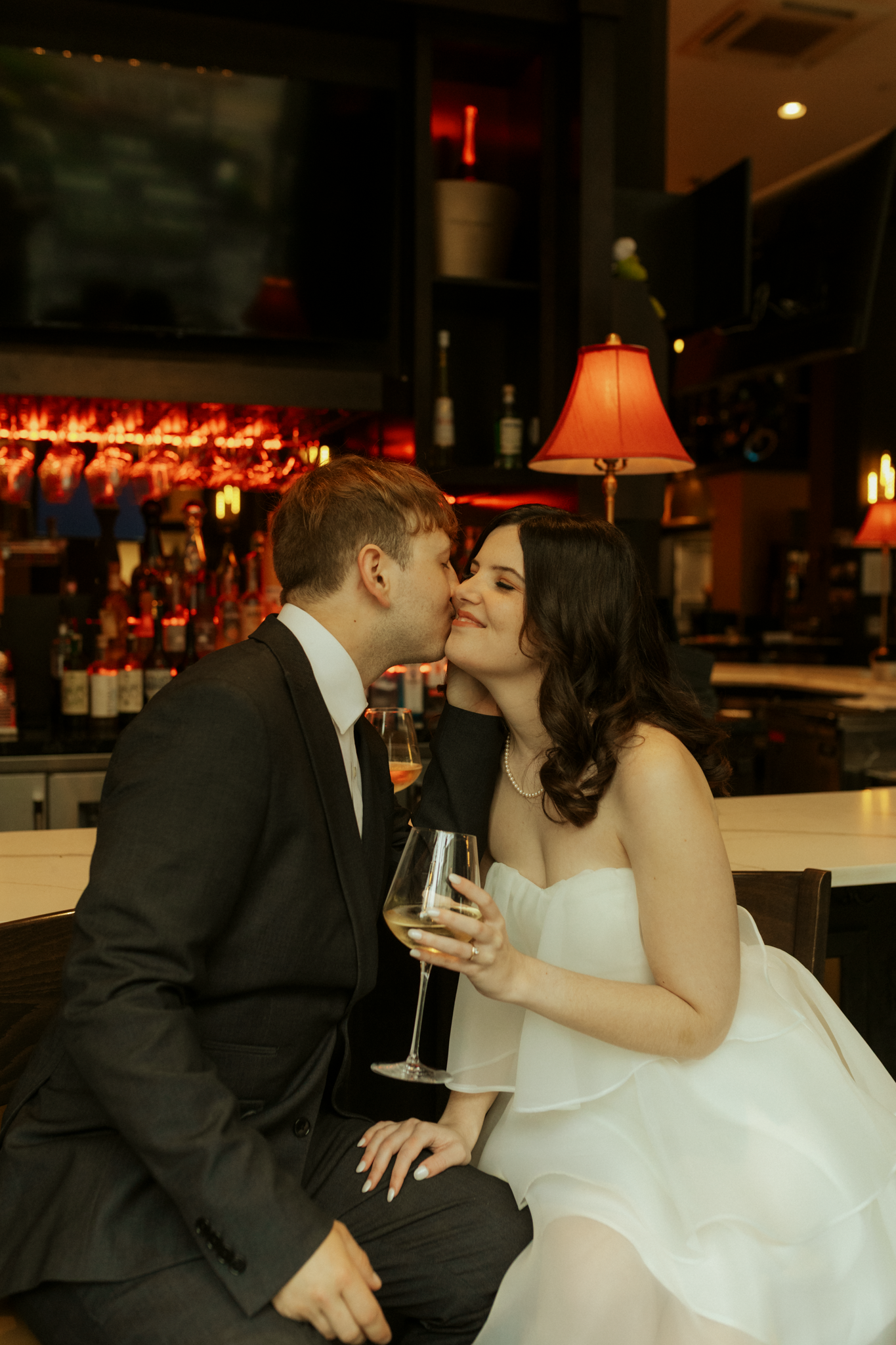couple dressed in fancy clothes at a cocktail lounge for their engagement photoshoot in Youngstown Ohio