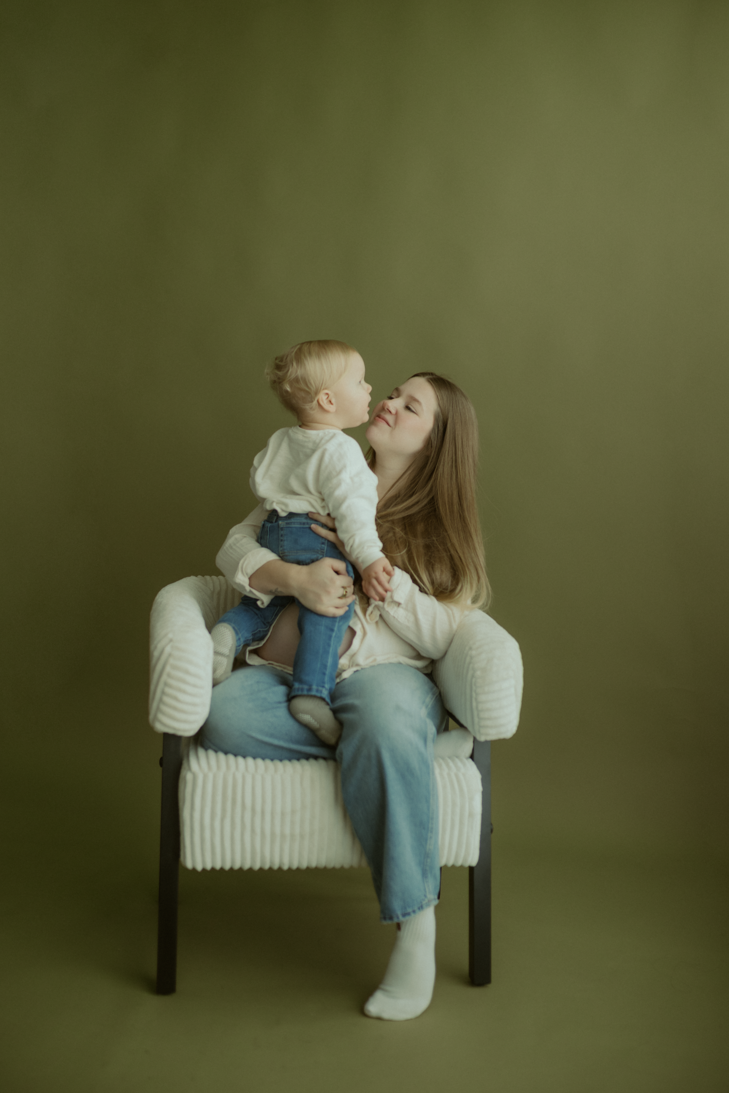mother and son share a hug in a studio for a maternity photoshoot in Hubbard Ohio