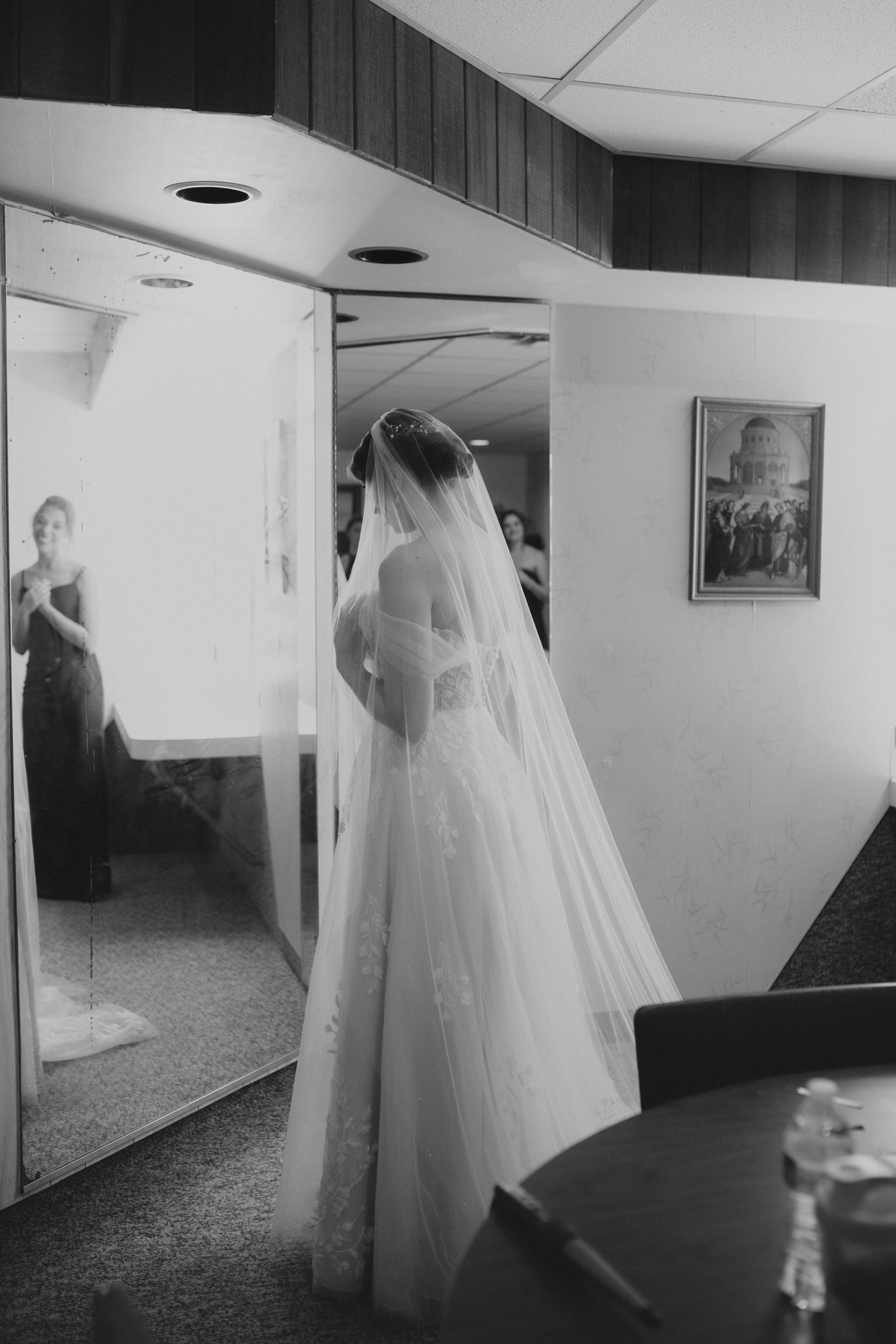 bride looks at herself in the mirror before the wedding ceremony in Cuyahoga Ohio