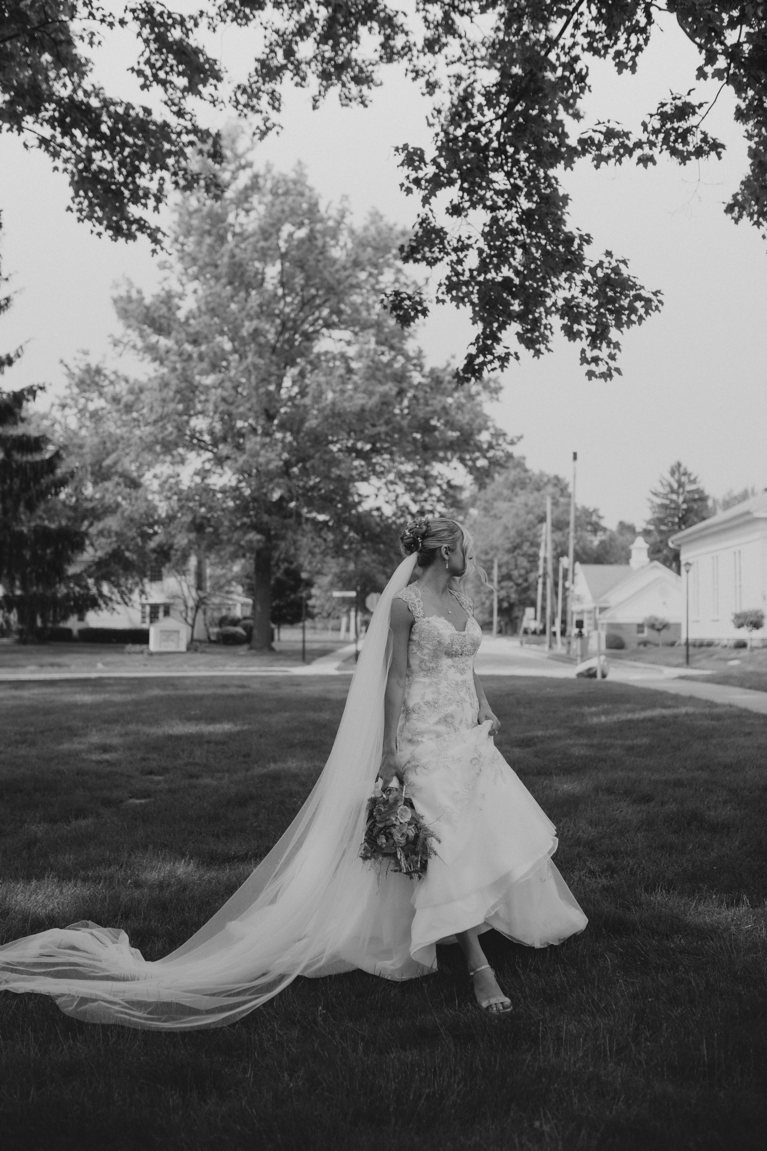 beautiful bride poses for solo portraits outdoors in Hudson, Ohio