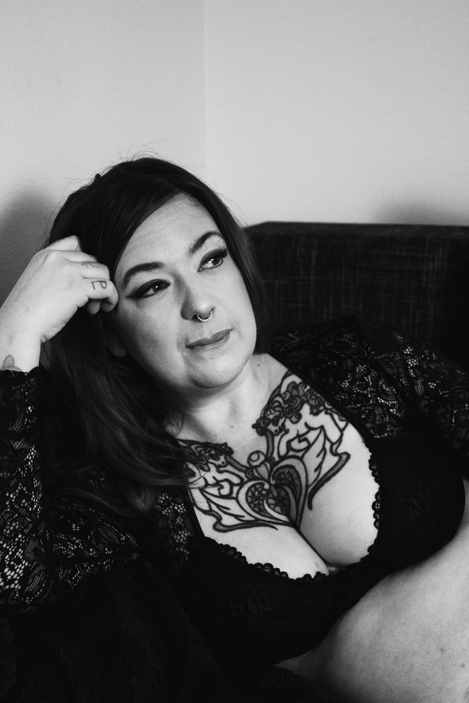 Black and white portrait series showing artistic poses on a dark couch.