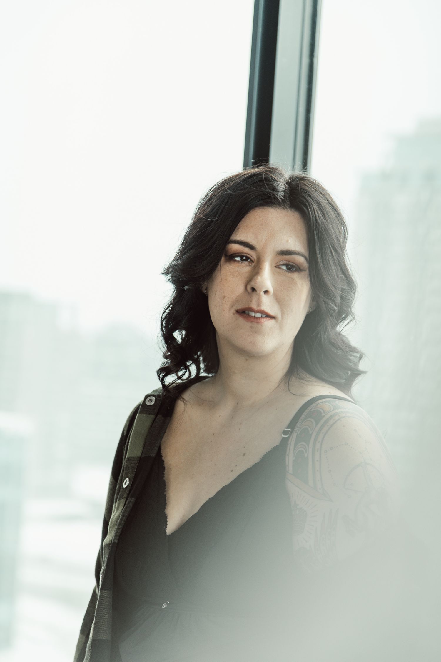 Artistic portrait series showing dark-haired figure against bright window background.