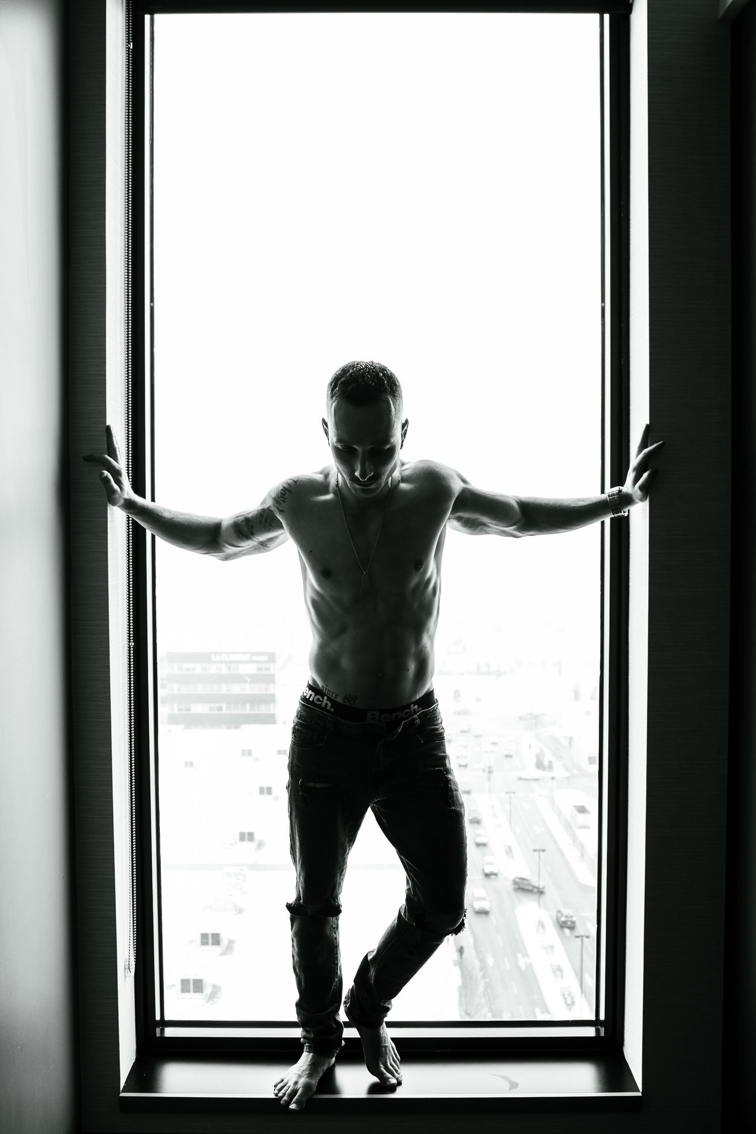 Dramatic silhouettes of a figure posing against bright windows in a triptych composition.