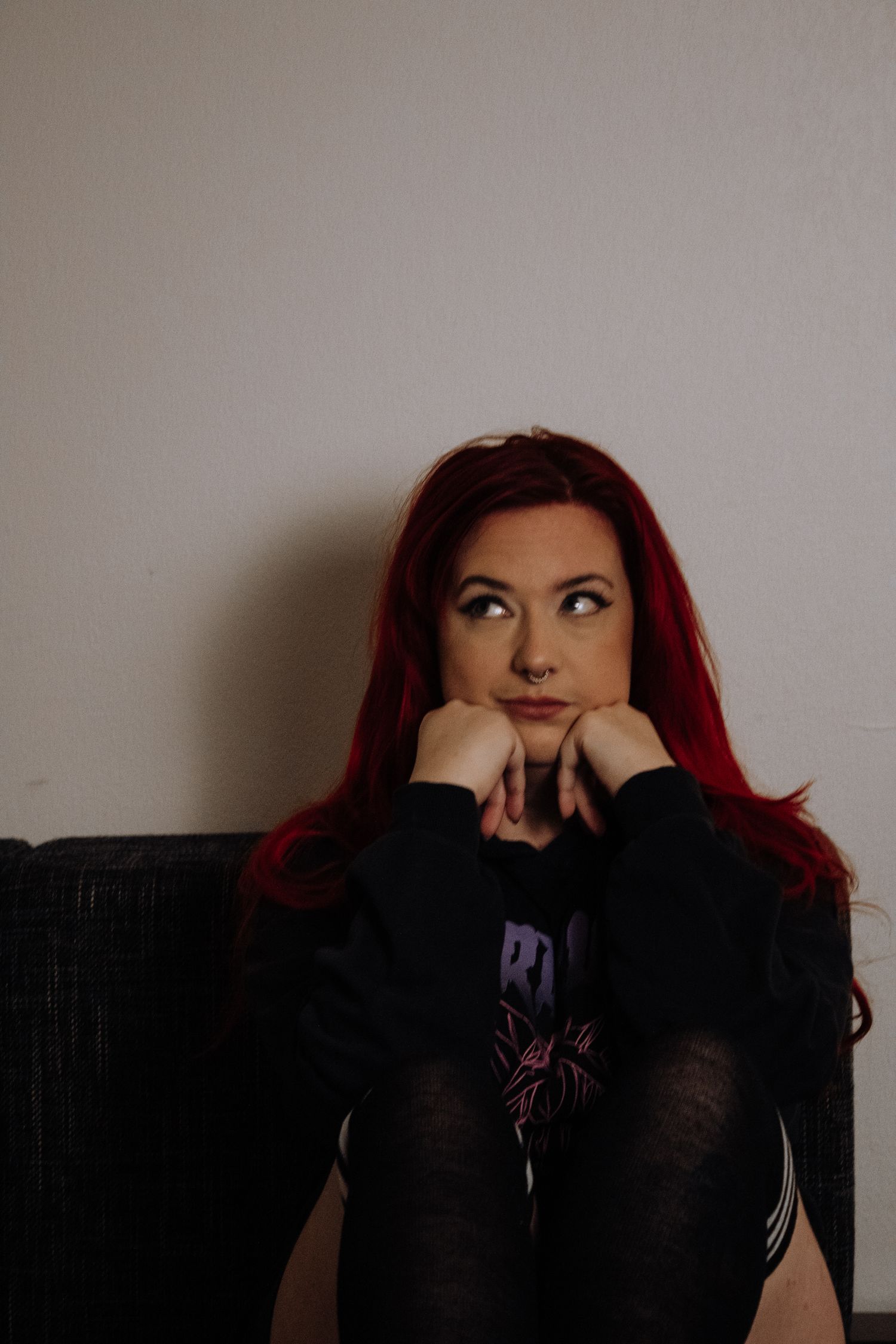Dramatic portraits with red hair against a light background in various contemplative poses.