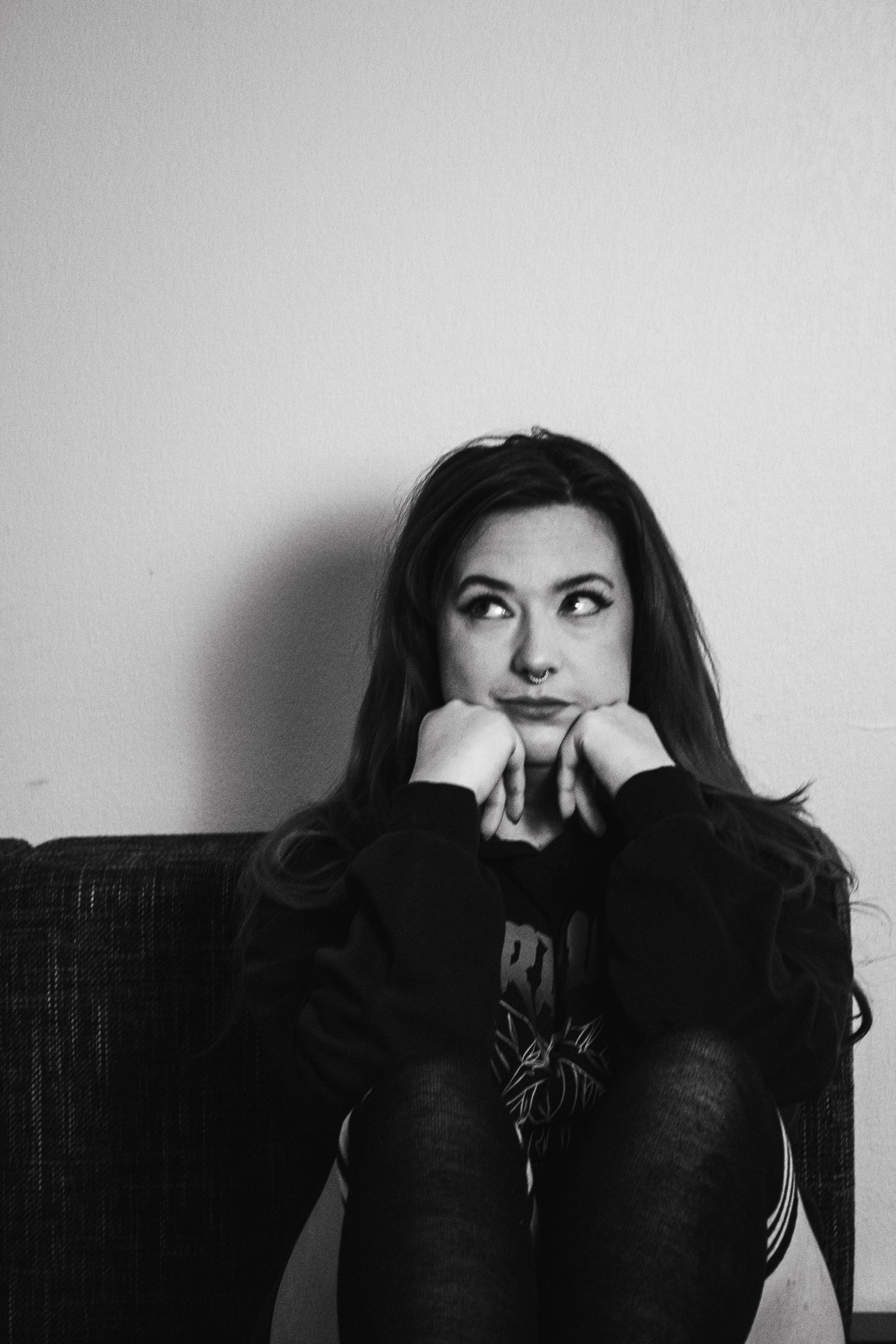 A series of black and white portraits showing expressive poses with dramatic lighting and shadows.
