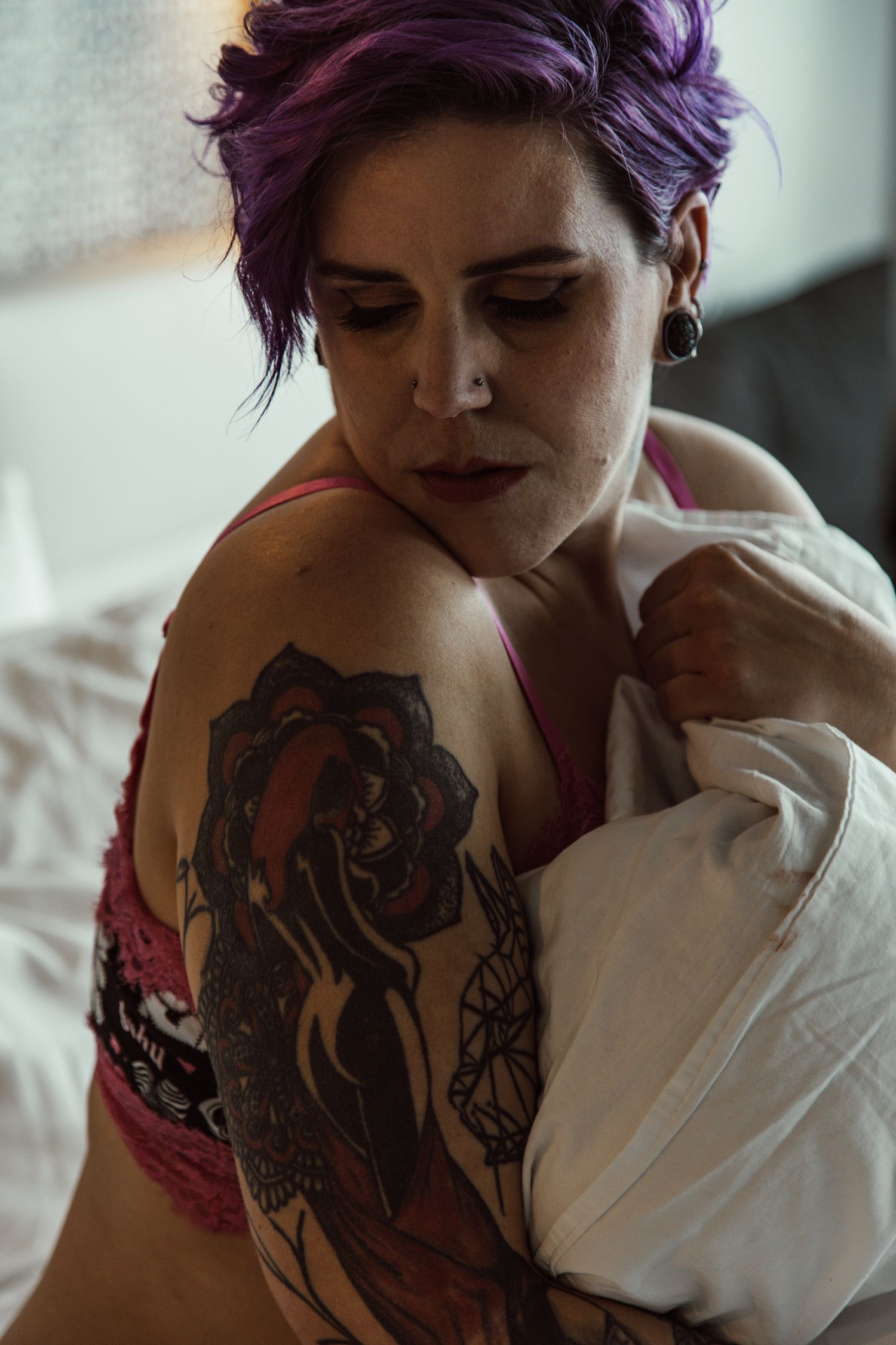 Moody portrait series highlighting intricate tattoo designs.